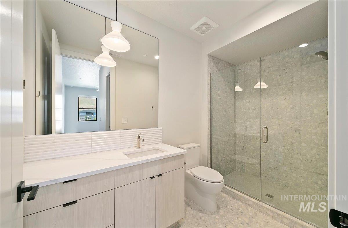 Bathroom with a stall shower and vanity