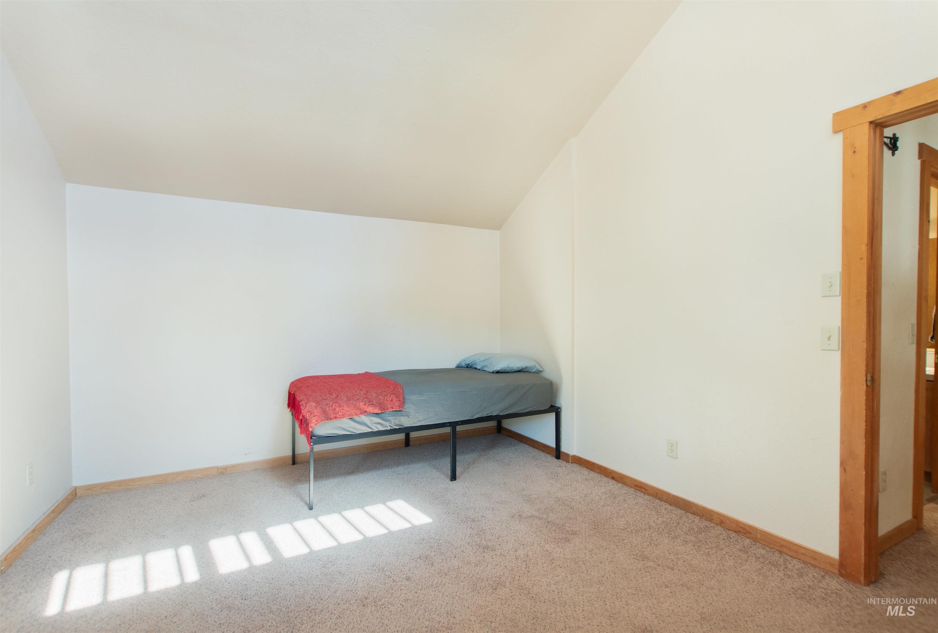 Sitting room featuring lofted ceiling and carpet floors