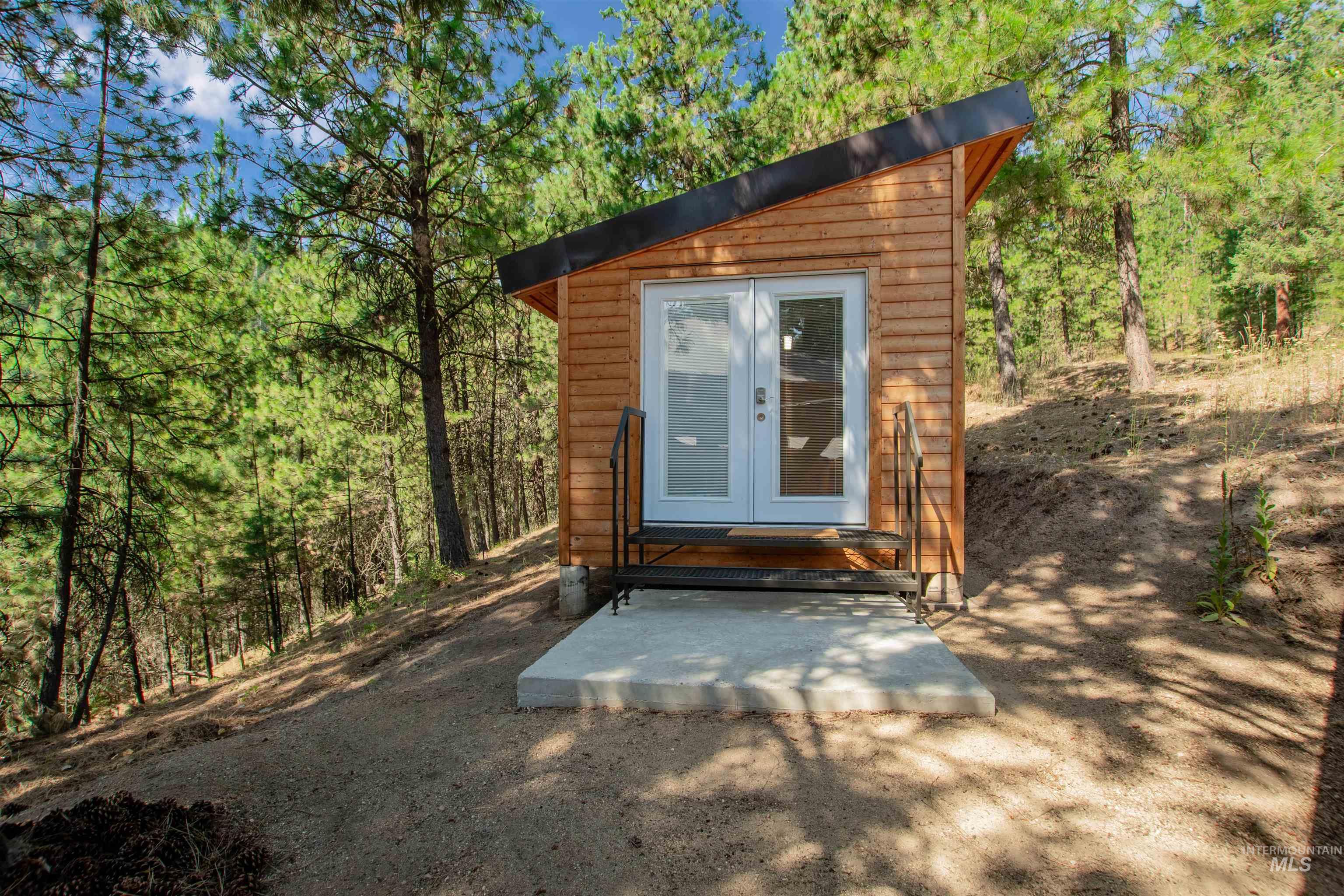 View of outbuilding with a forest view