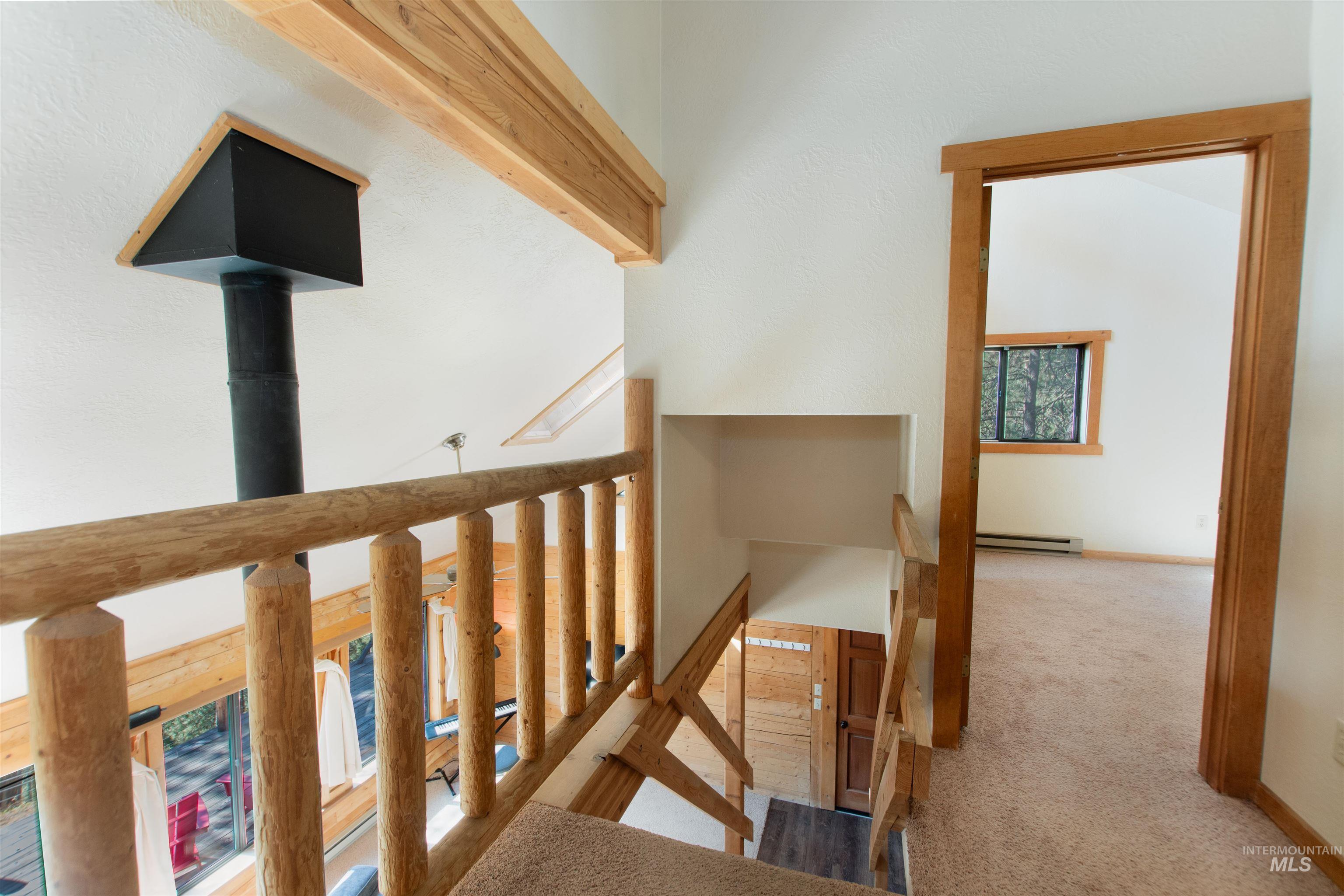 Staircase with carpet floors and baseboard heating