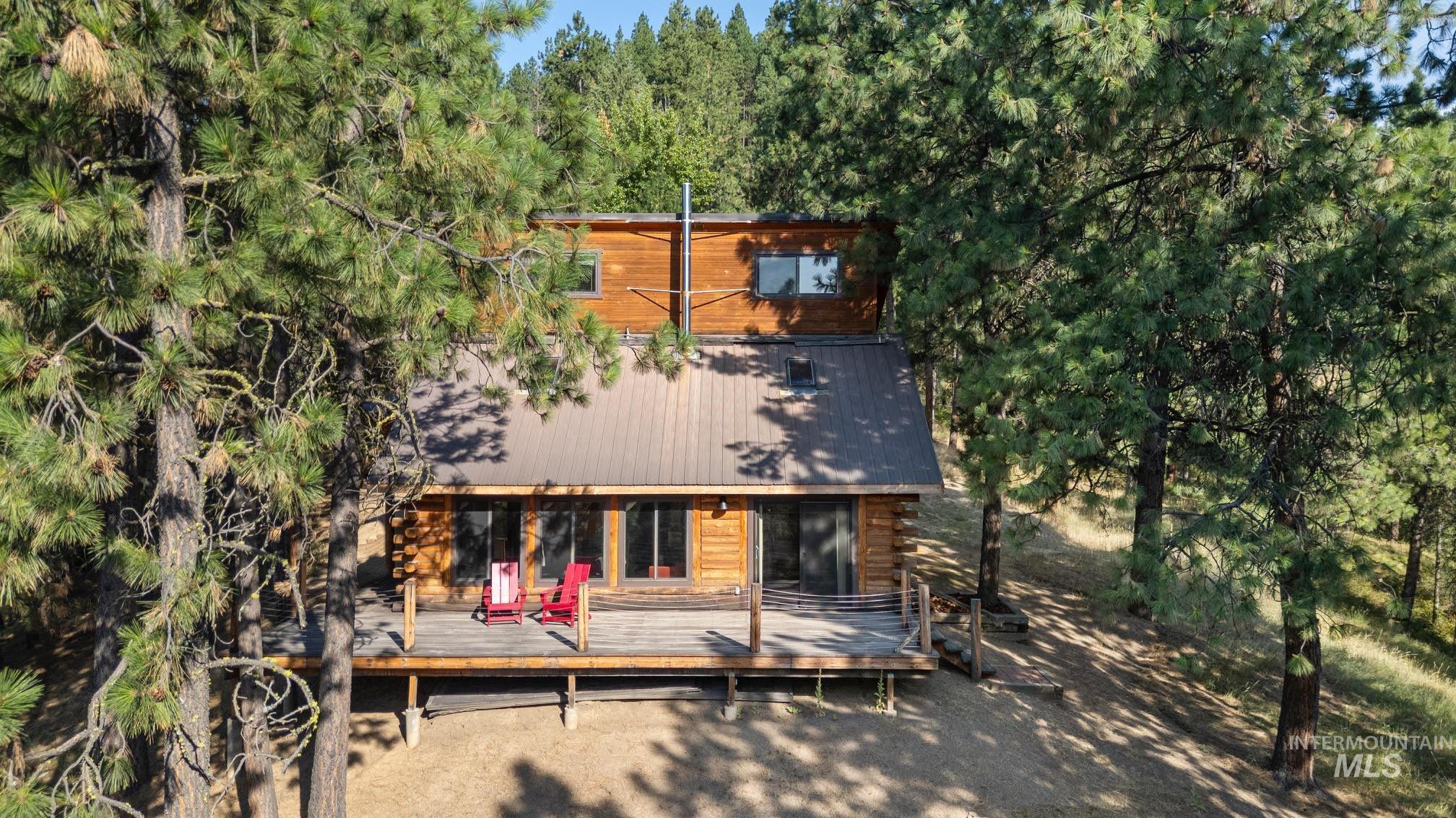 Rear view of property featuring a deck and log exterior