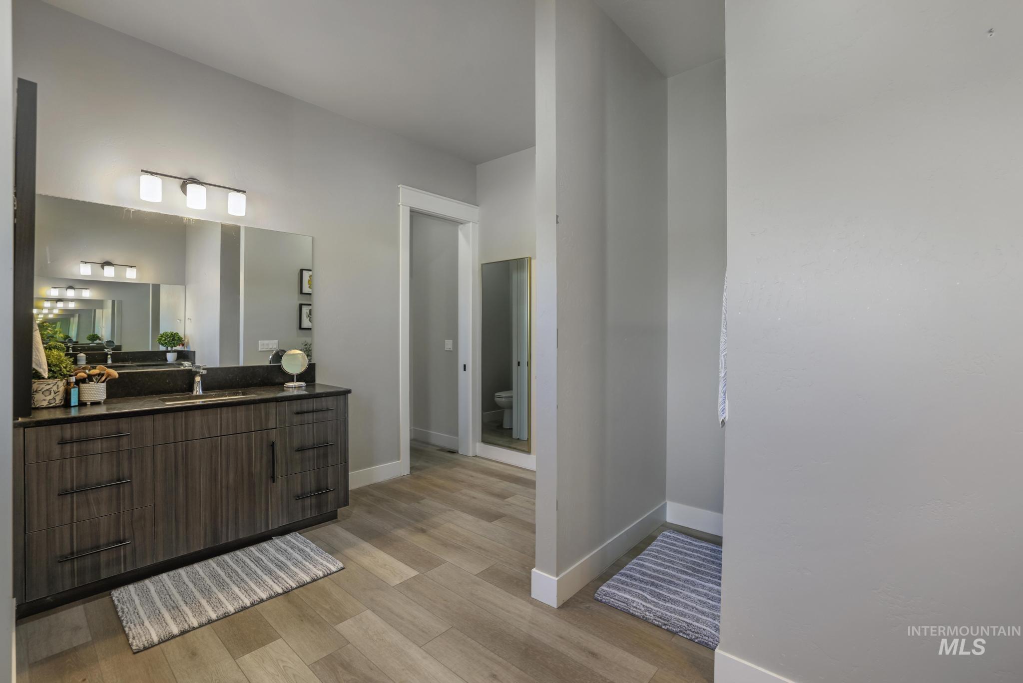 Bathroom featuring vanity and light wood finished floors