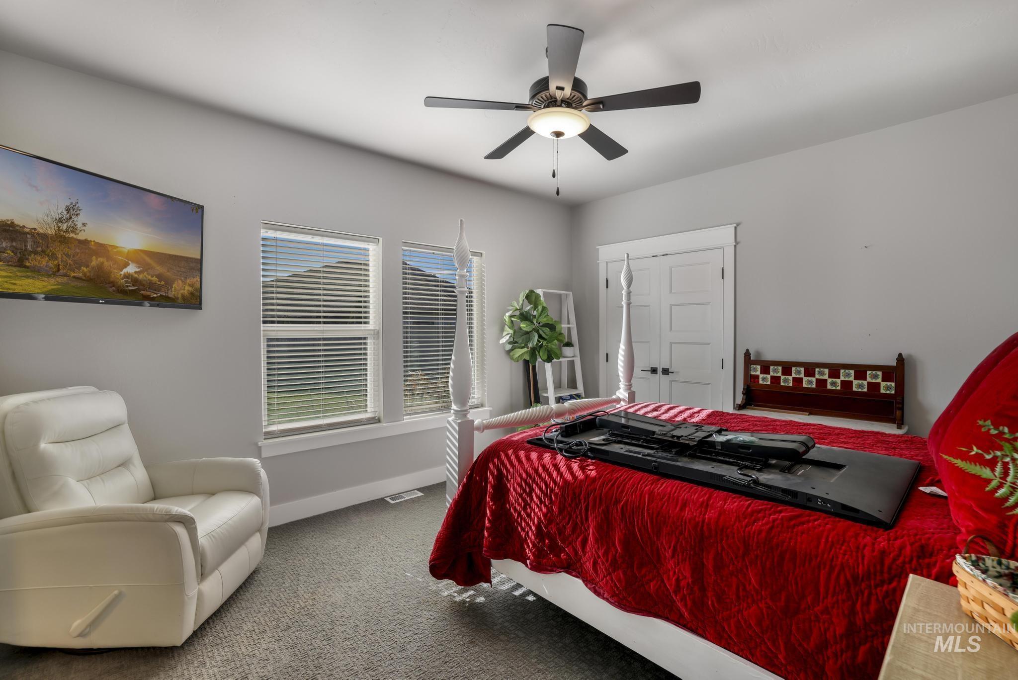 Bedroom with carpet flooring and a ceiling fan