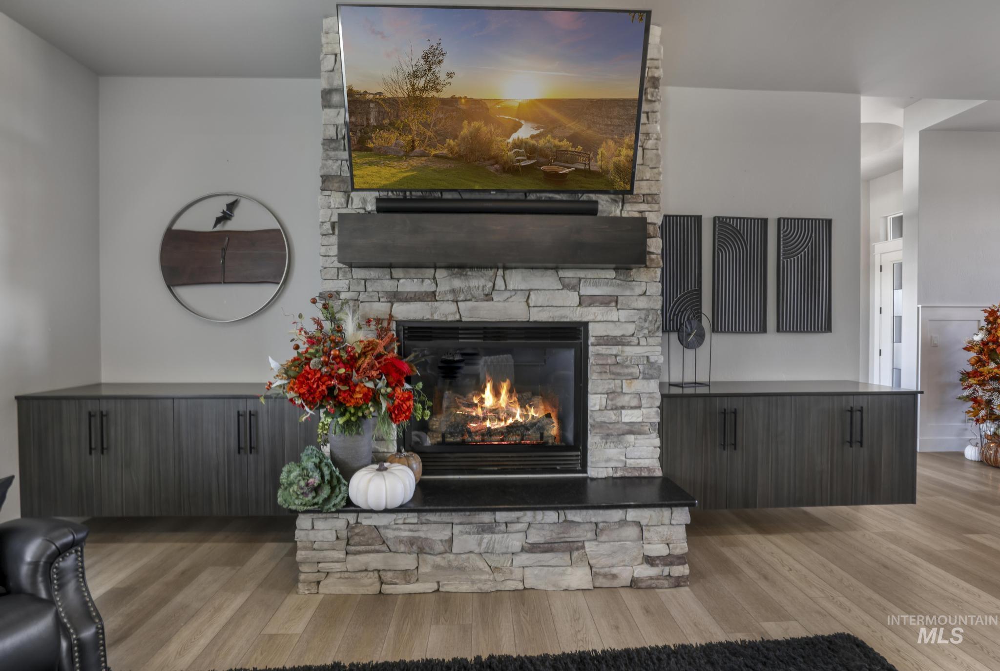 Living area with light wood-style floors and a fireplace