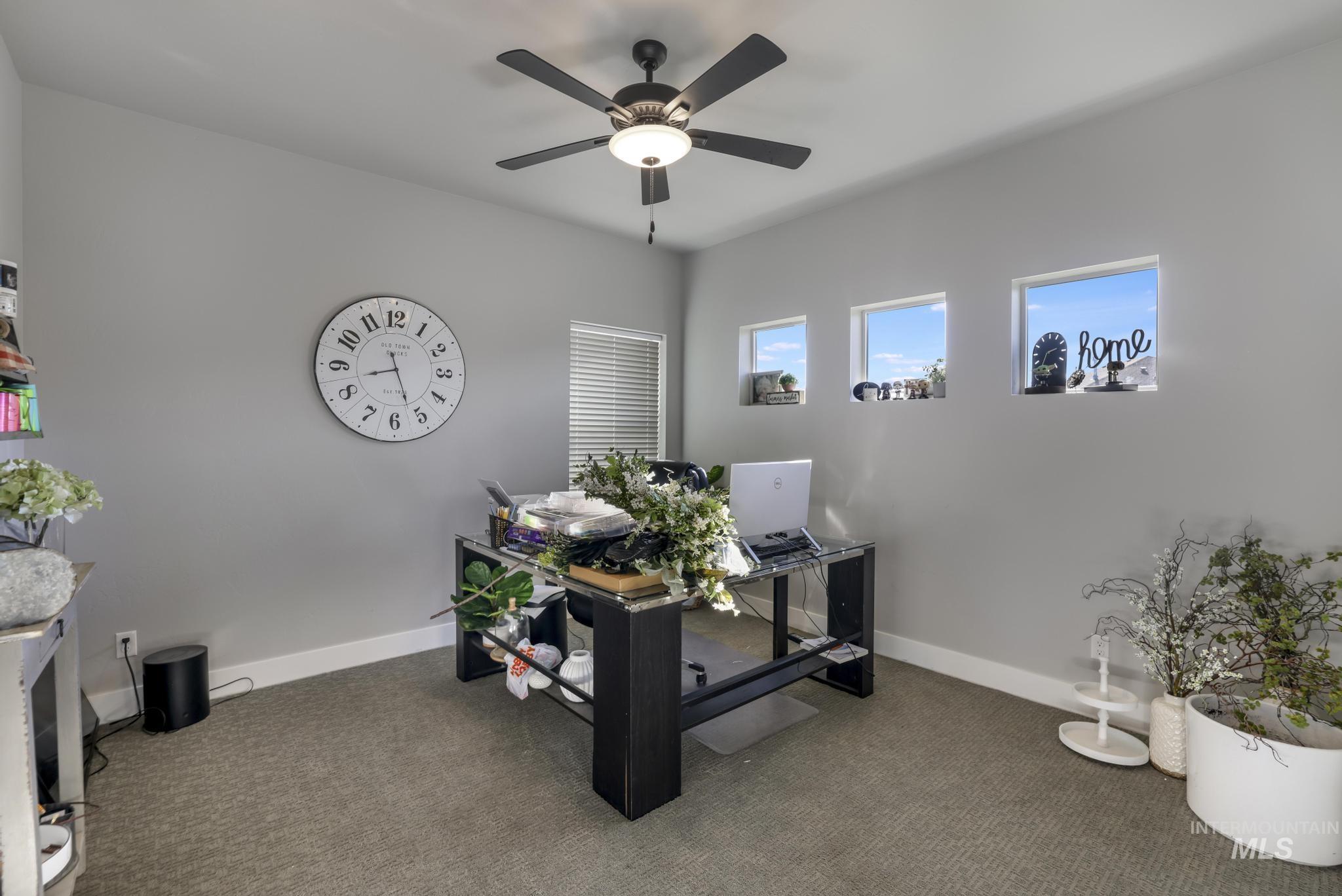 Office area featuring a ceiling fan