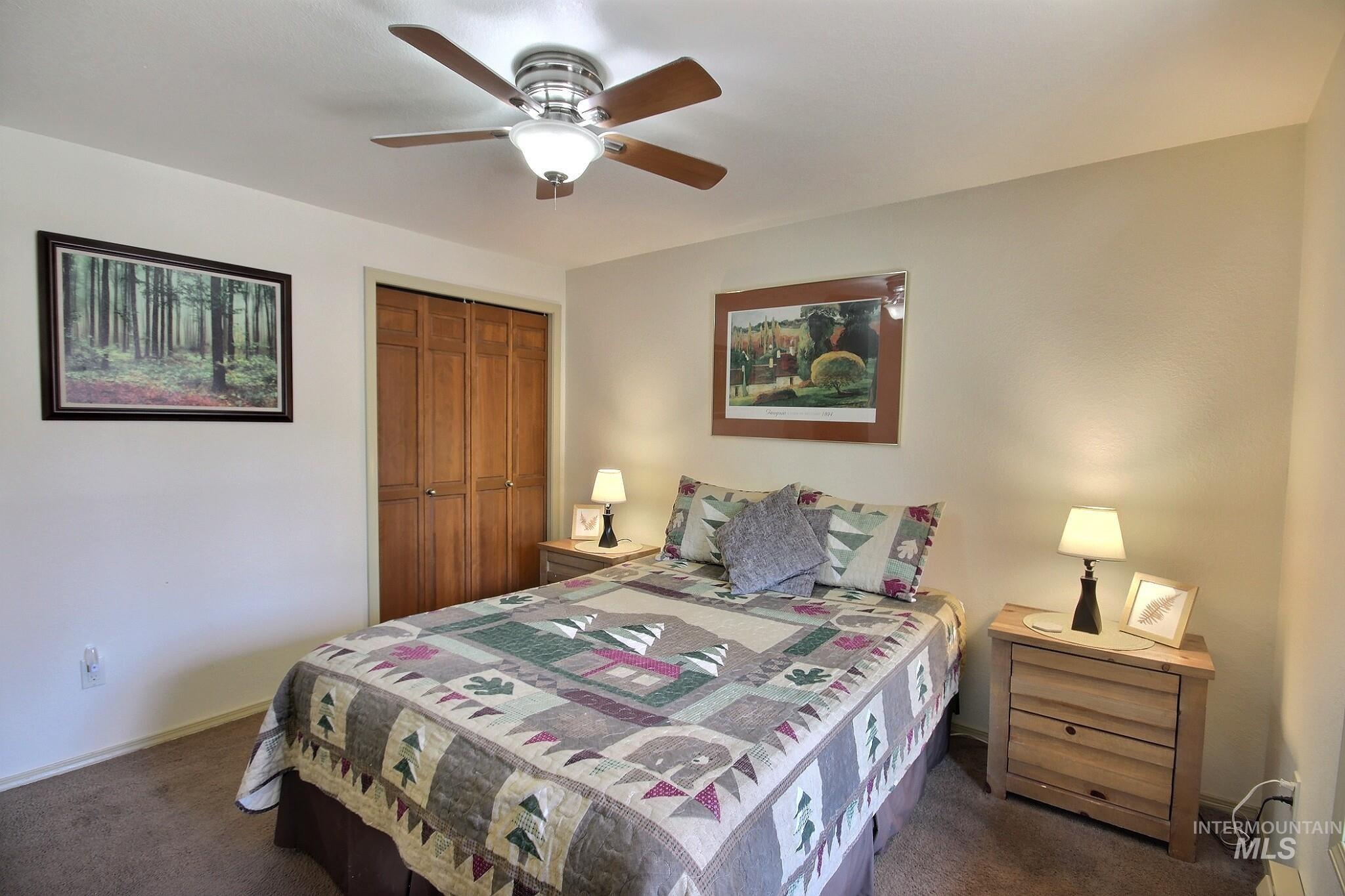 Bedroom with carpet floors, a closet, and ceiling fan