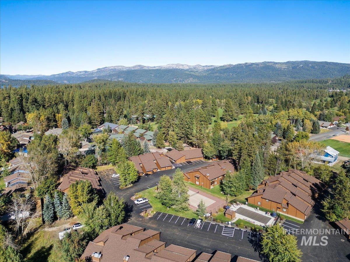 Aerial view of property's location with a heavily wooded area and nearby suburban area