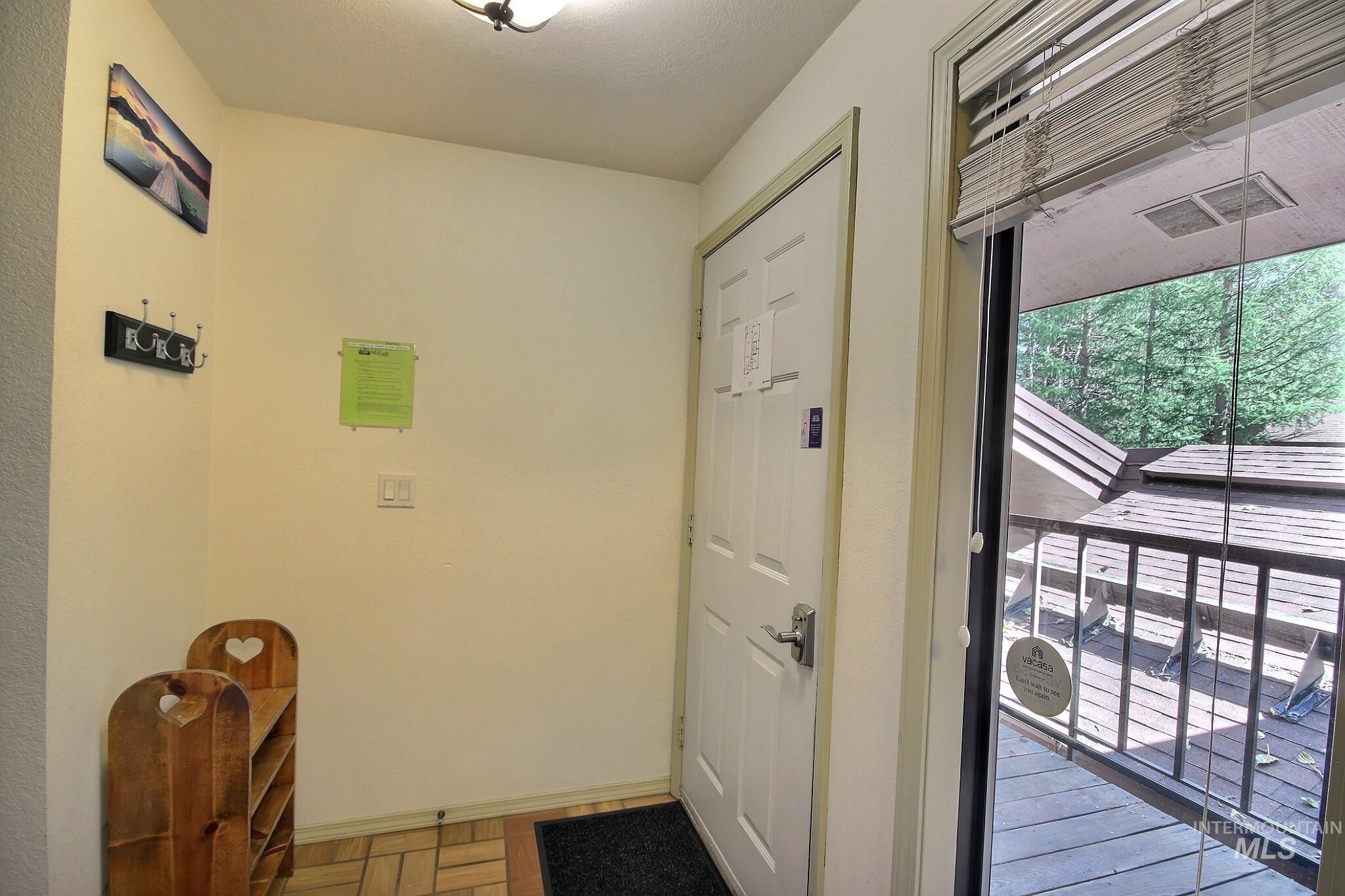 Doorway featuring baseboards