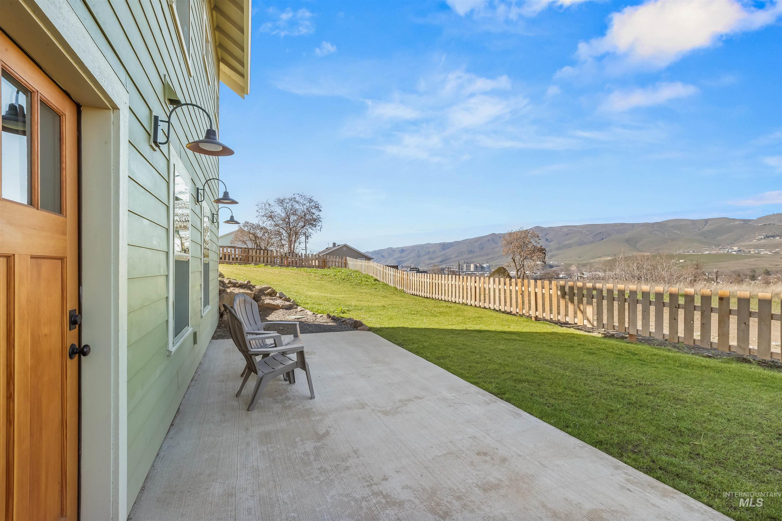 Fenced backyard with a patio area and a mountain view