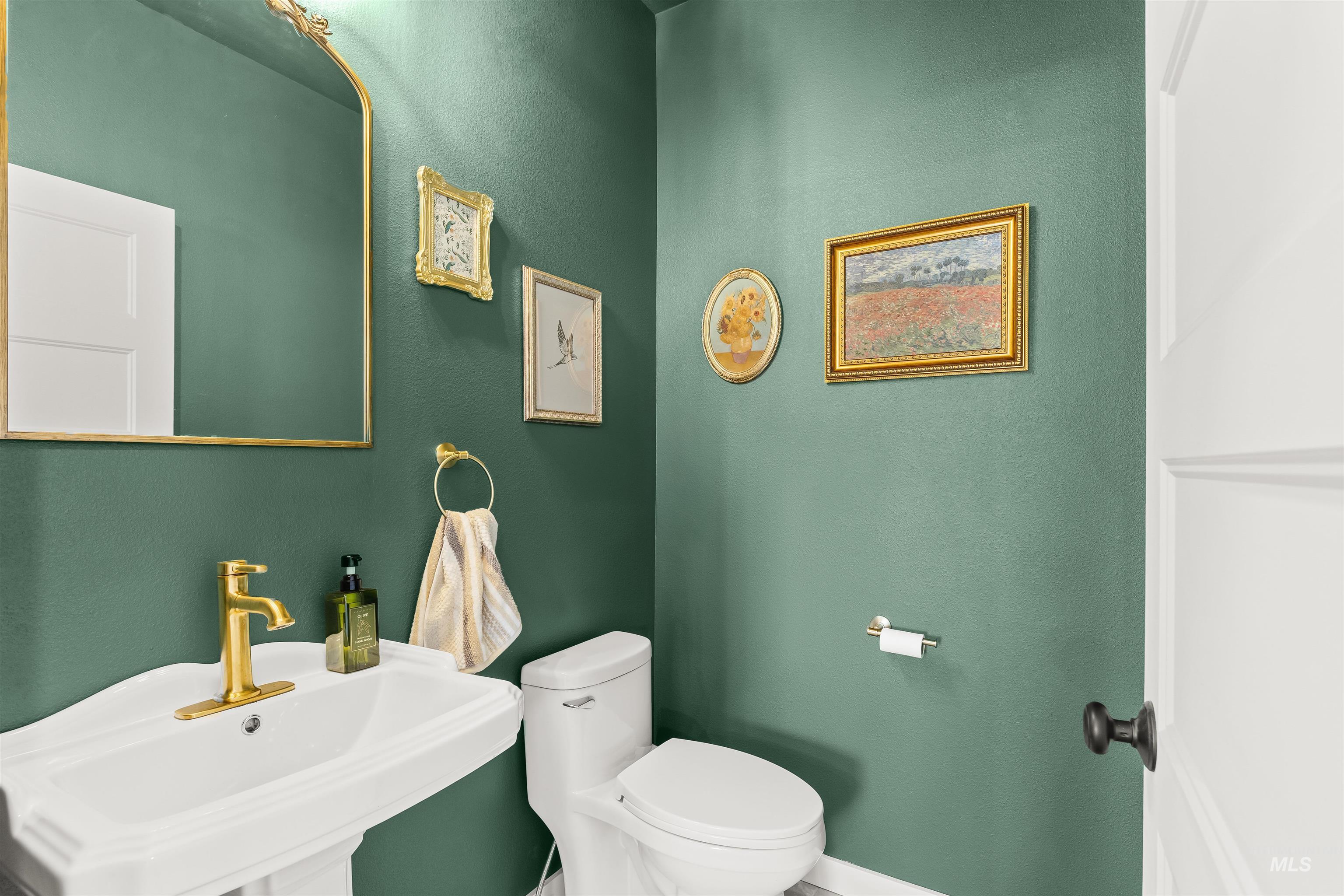 Bathroom featuring a textured wall and toilet