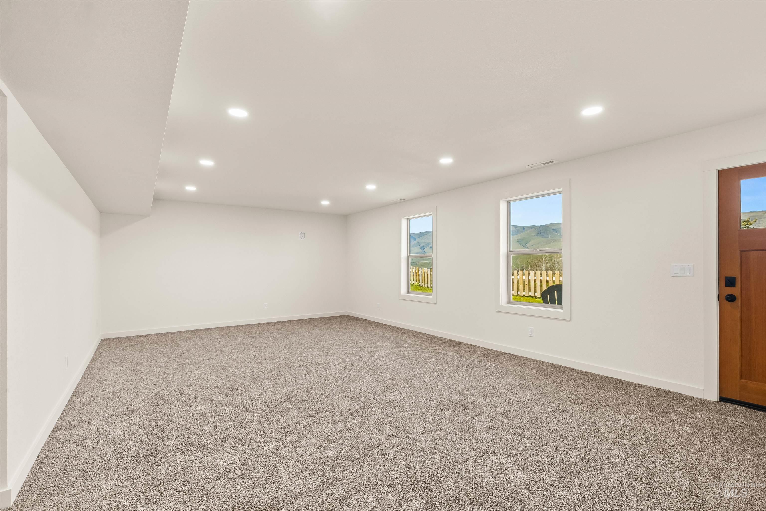Entrance foyer with carpet and recessed lighting