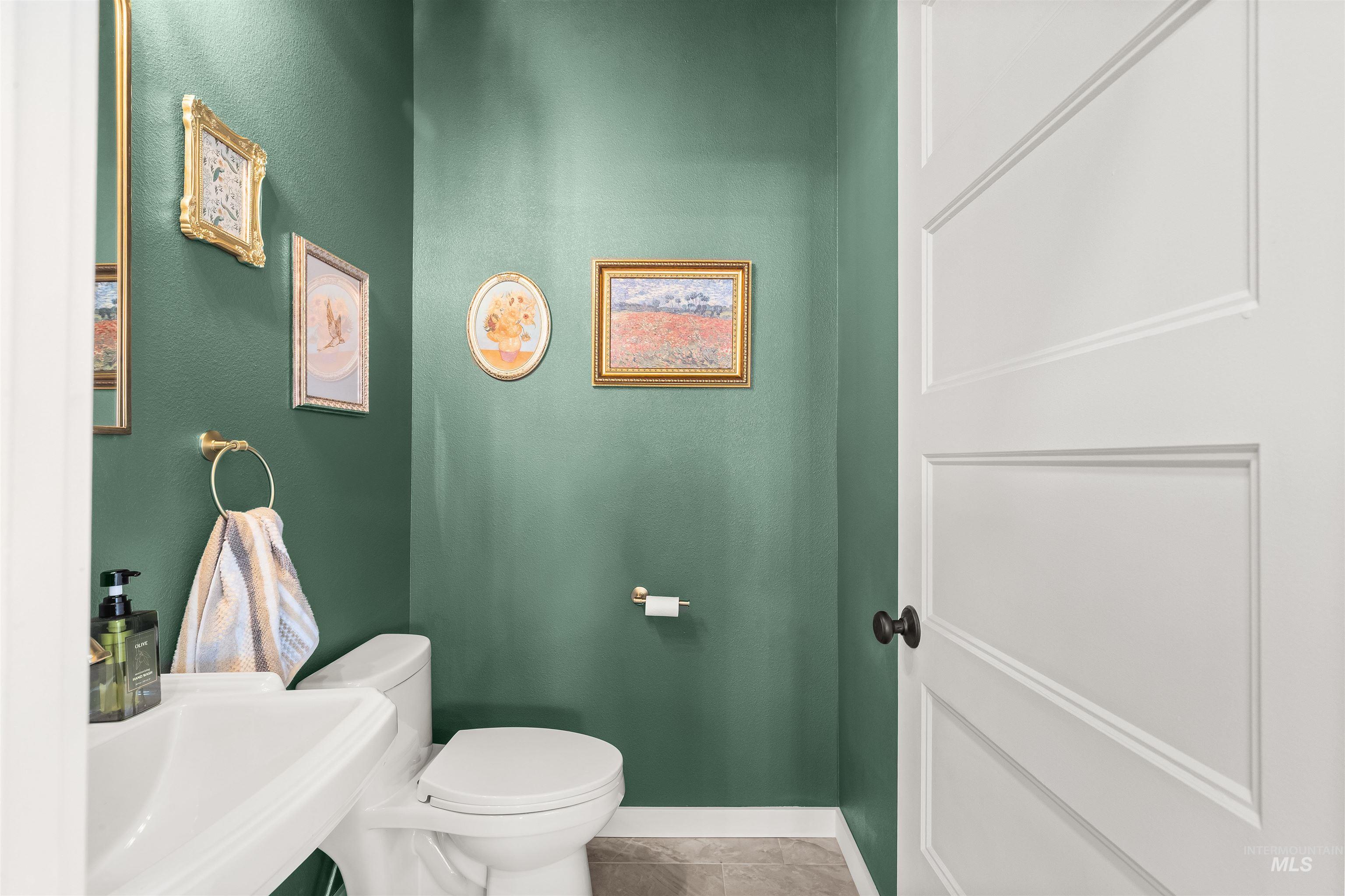 Half bath featuring light tile patterned floors and a textured wall