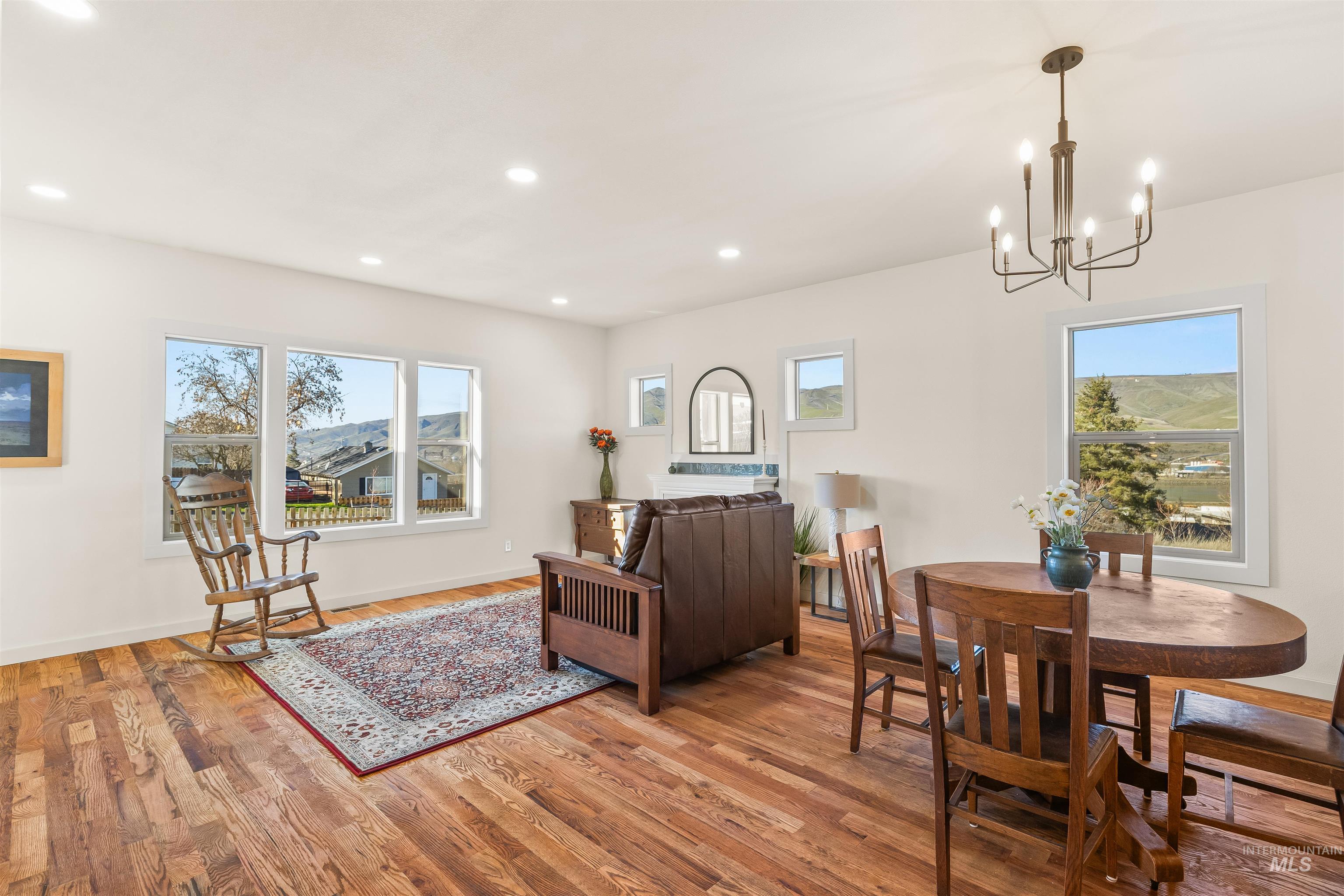 Living area featuring light wood finished floors and a chandelier
