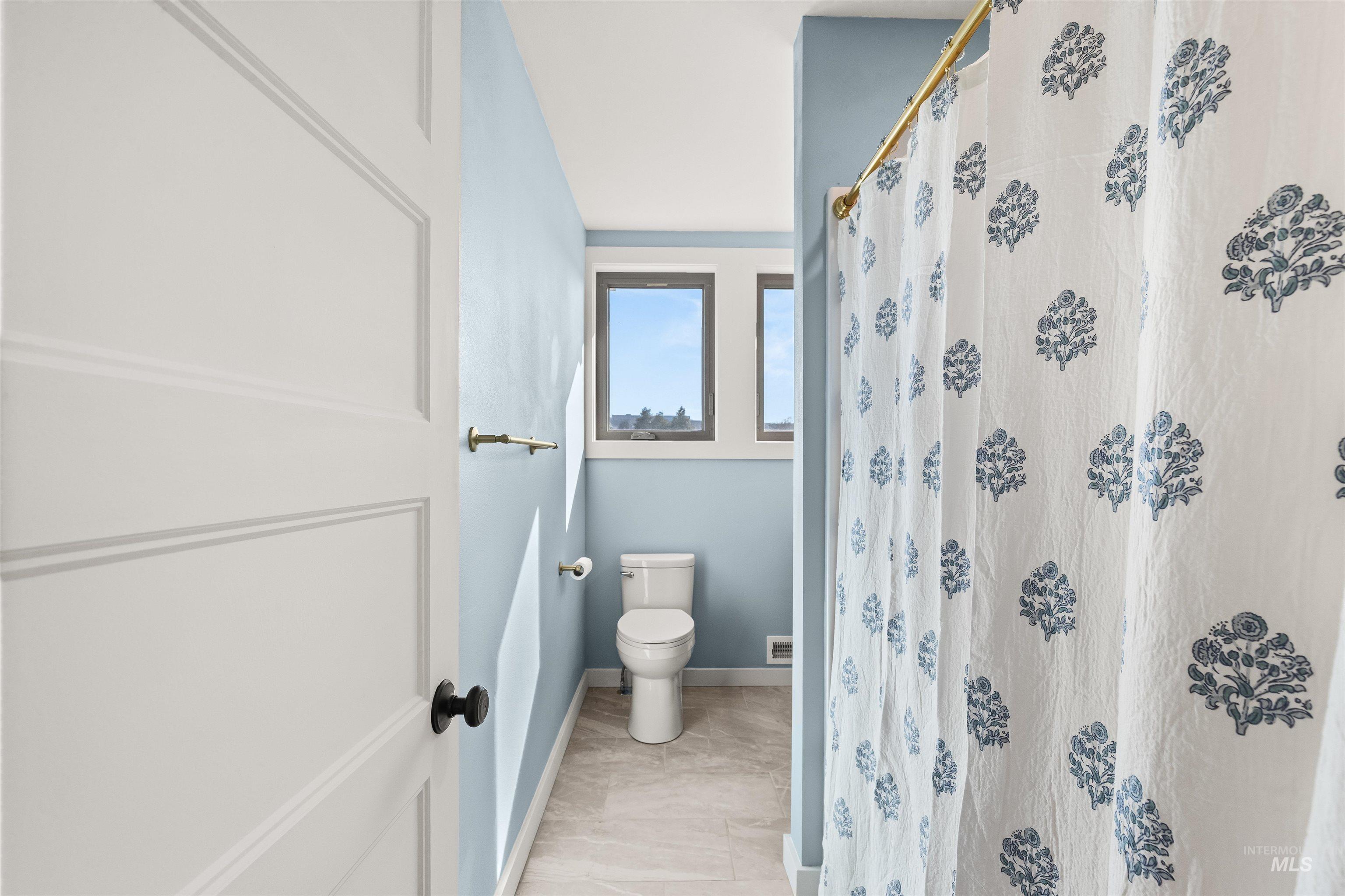 Bathroom featuring curtained shower