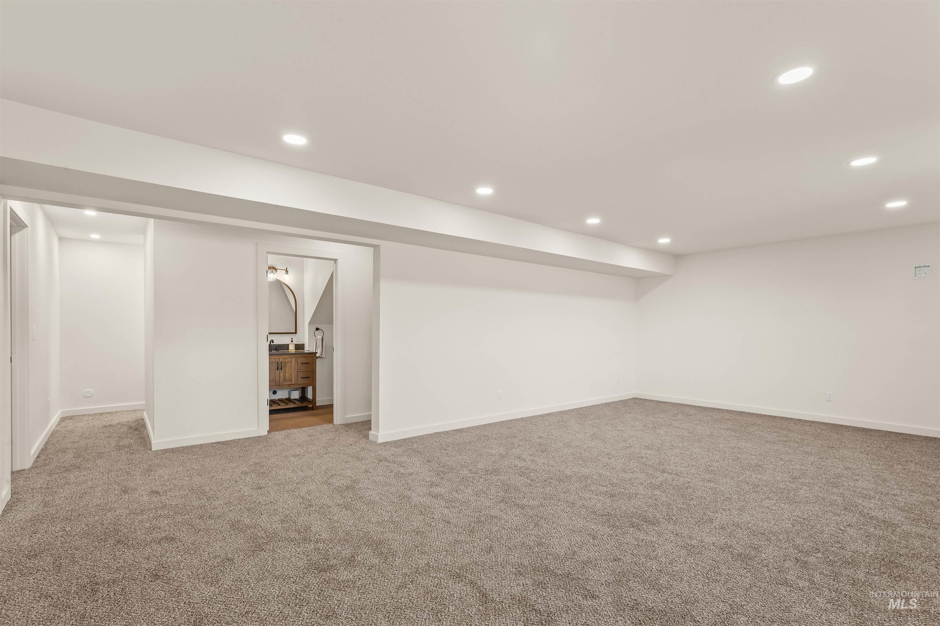 Finished below grade area featuring recessed lighting and carpet floors