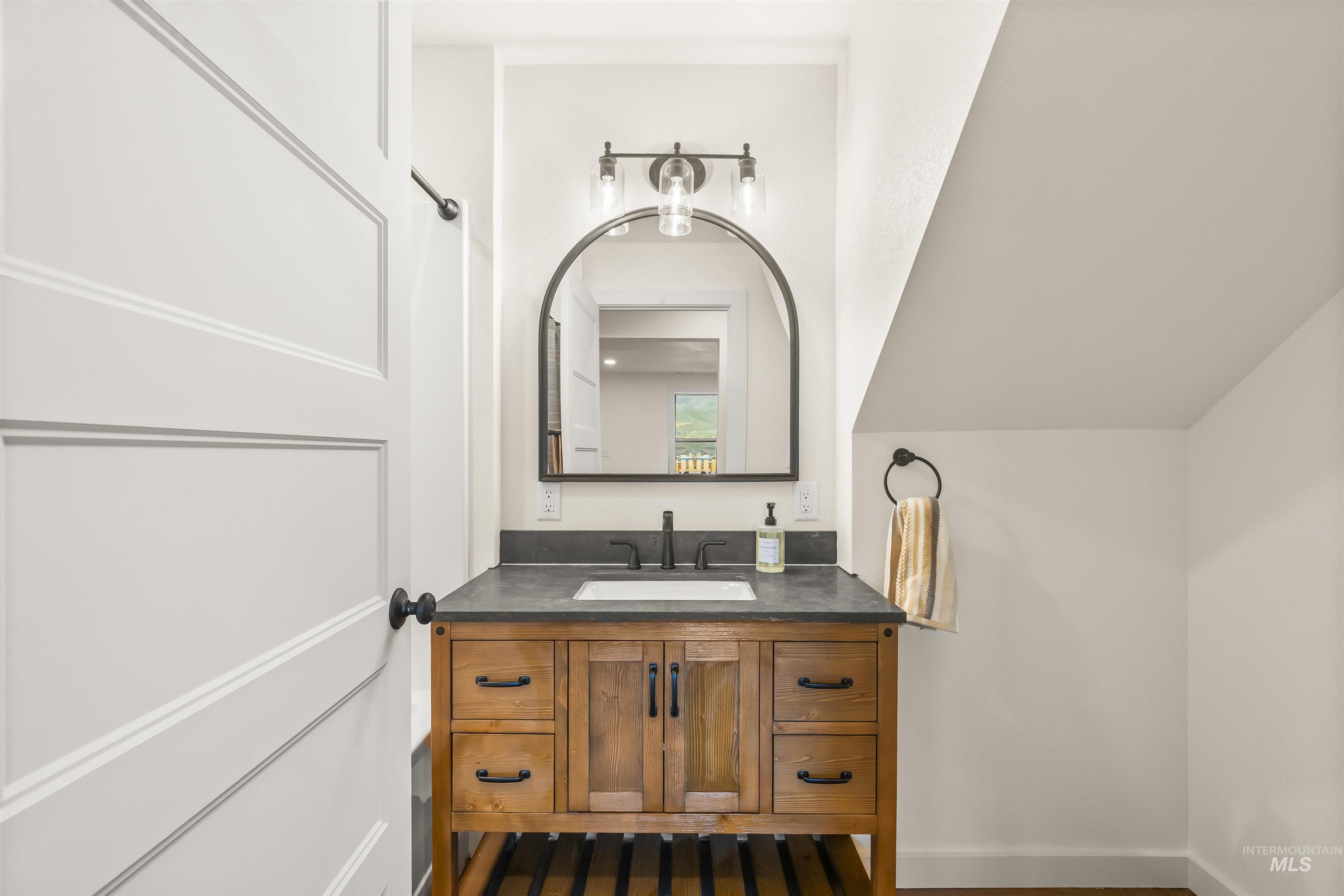 Bathroom with vanity and baseboards