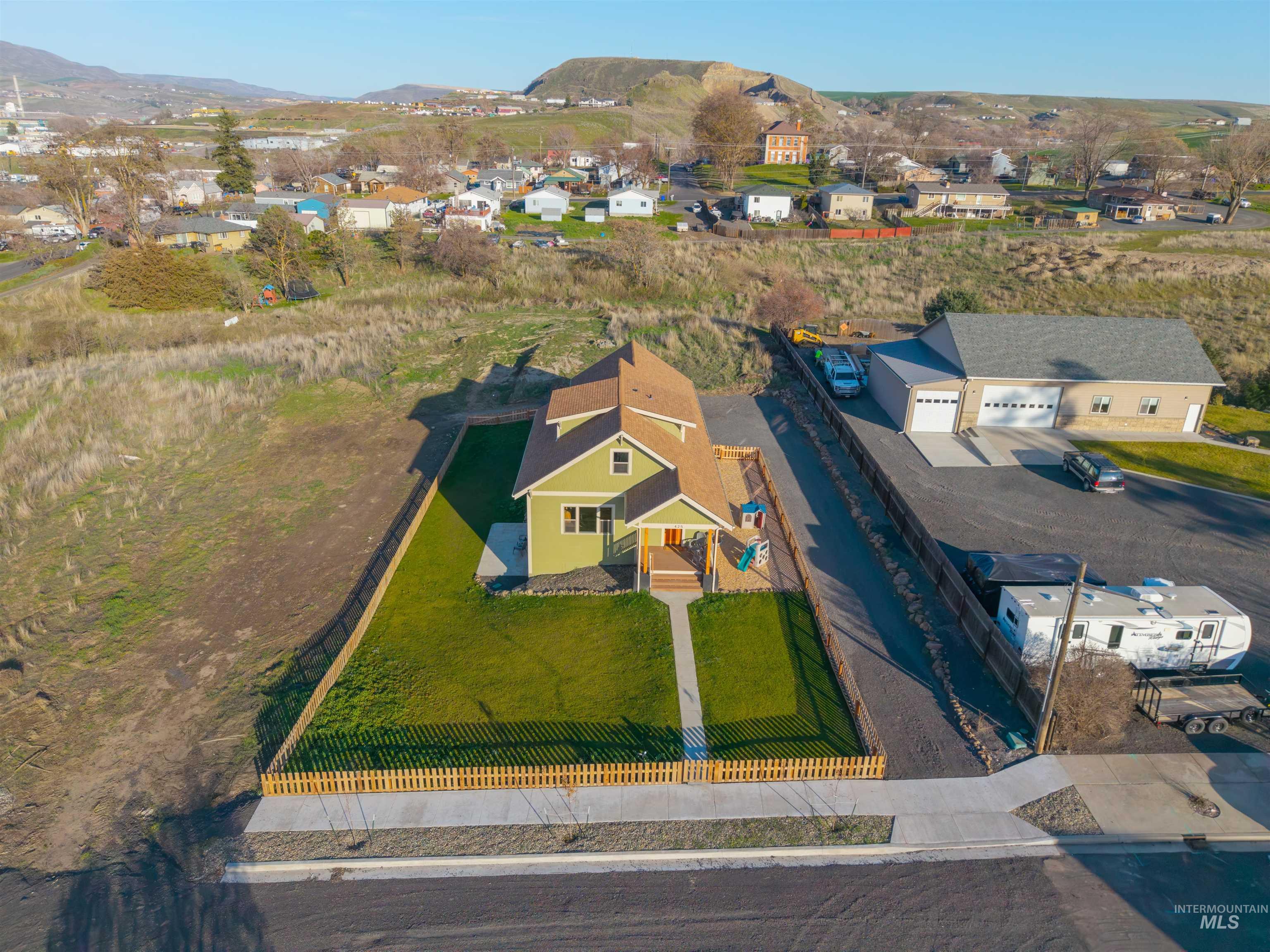 Aerial perspective of suburban area featuring a mountain backdrop