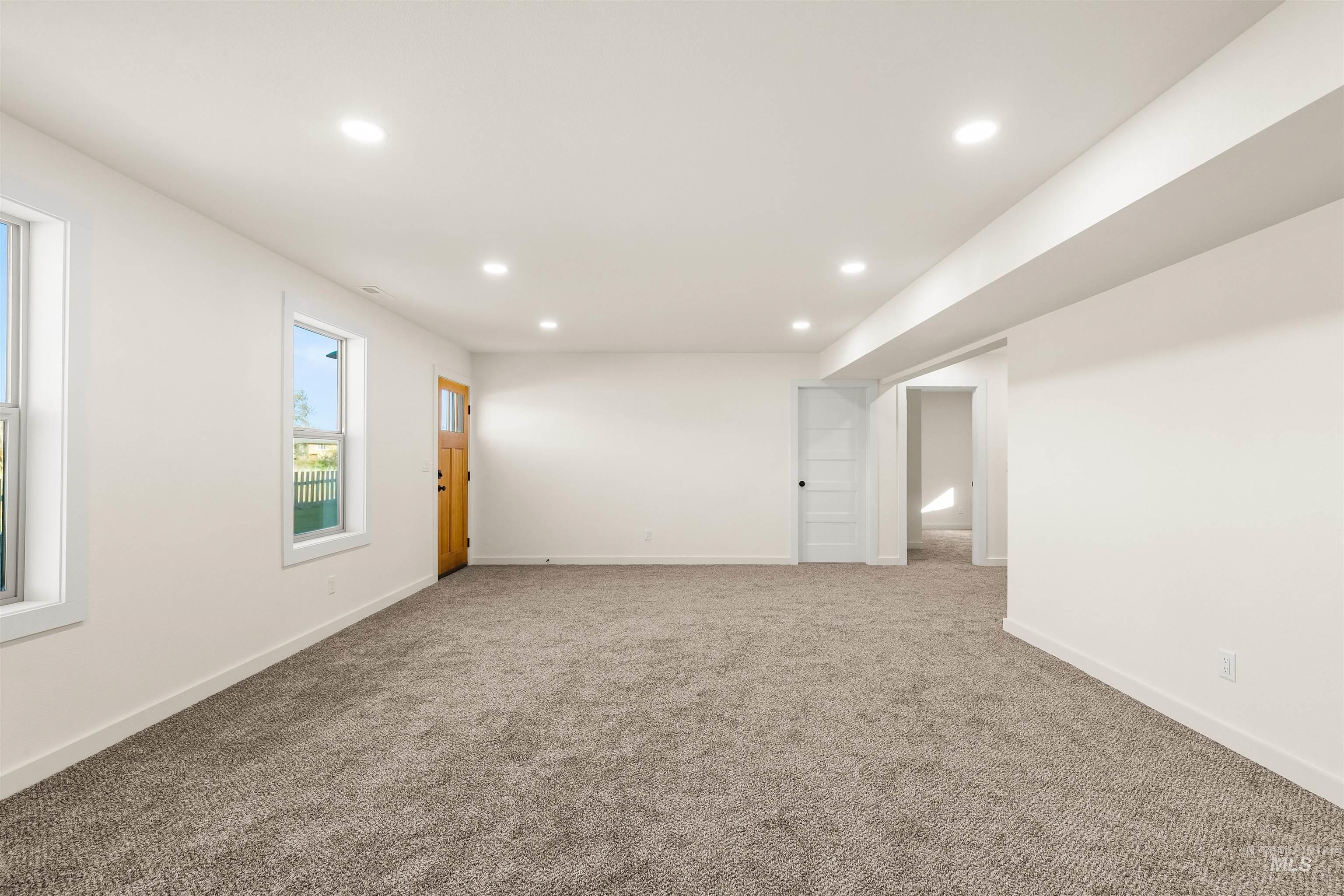 Empty room with recessed lighting and carpet