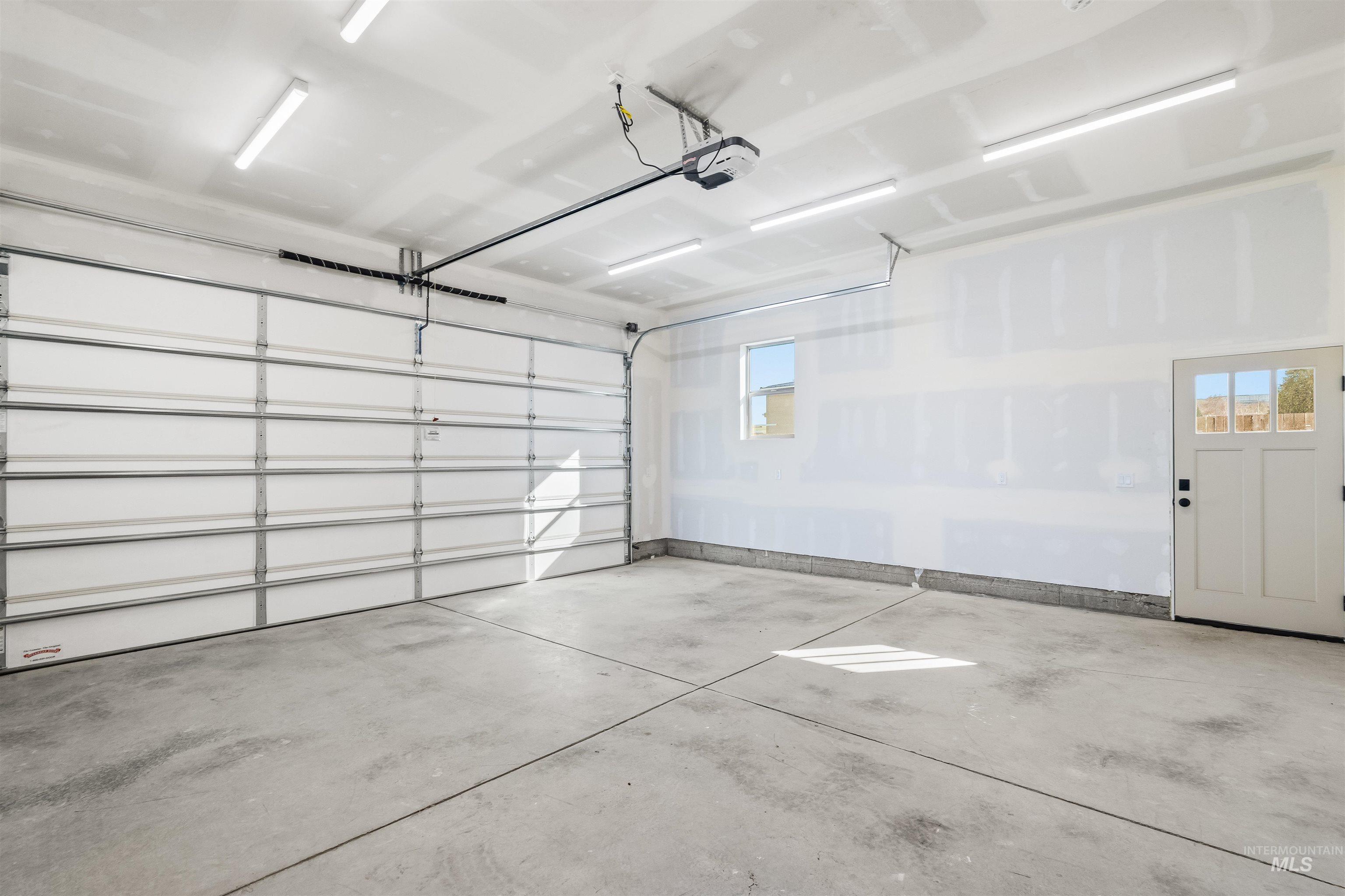 Garage featuring a garage door opener