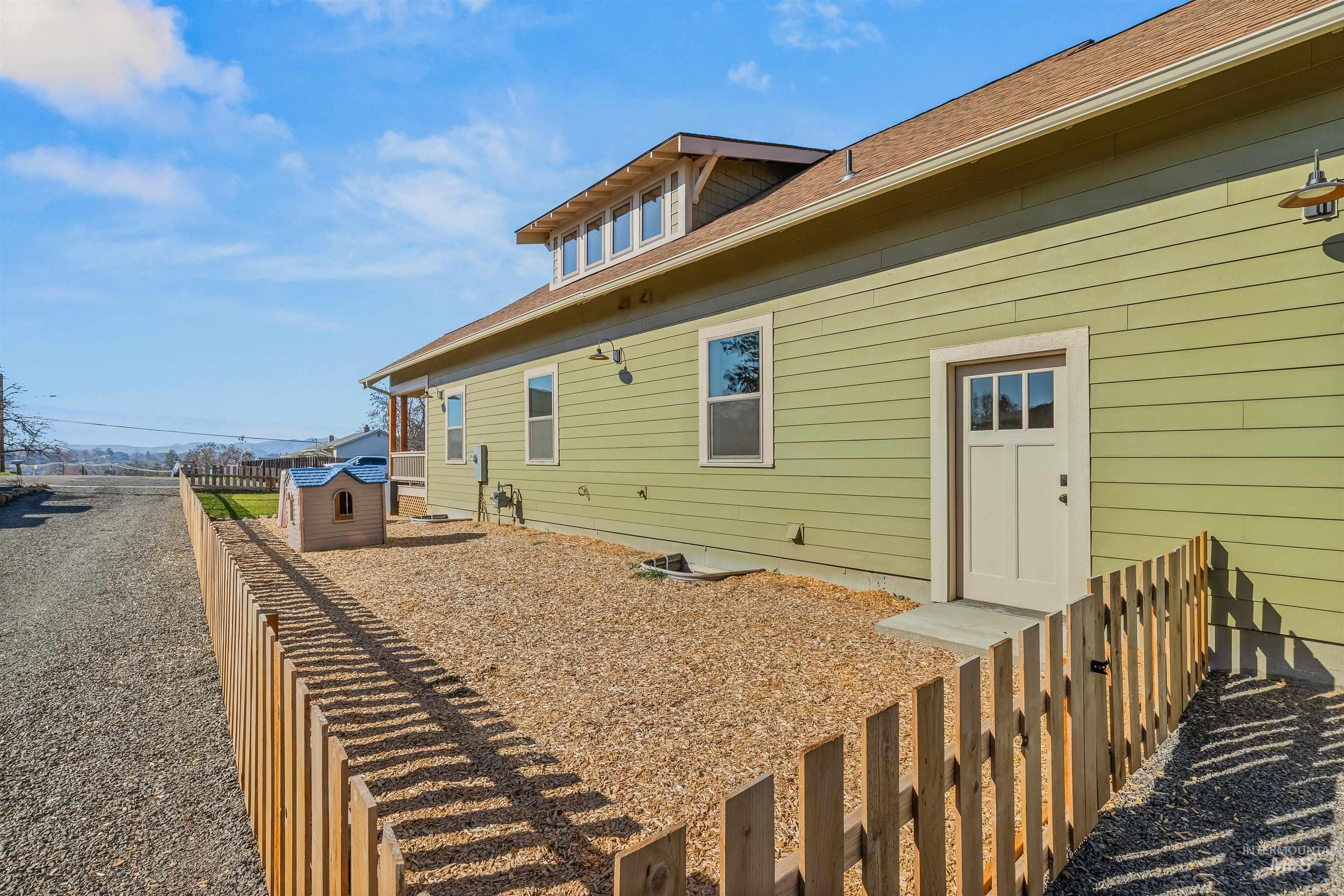 Back of property with a fenced backyard, a shed, and a shingled roof