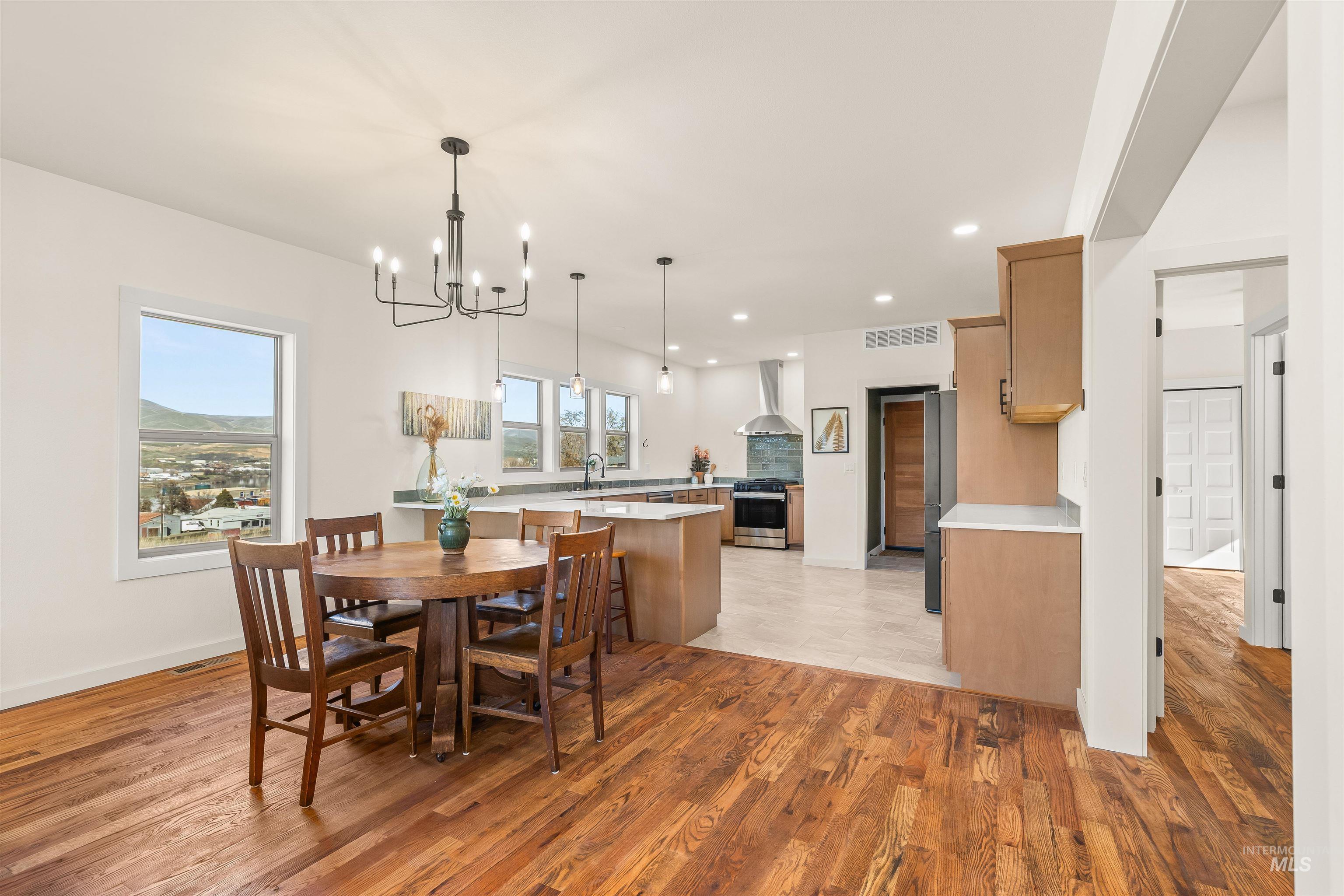 Dining room featuring light wood-style floors and hanging lights