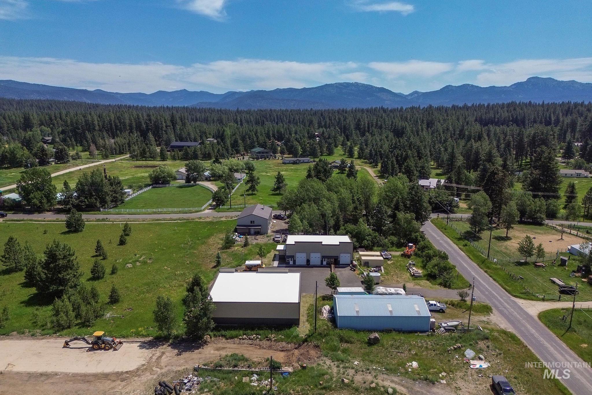 Drone / aerial view of a heavily wooded area and mountains