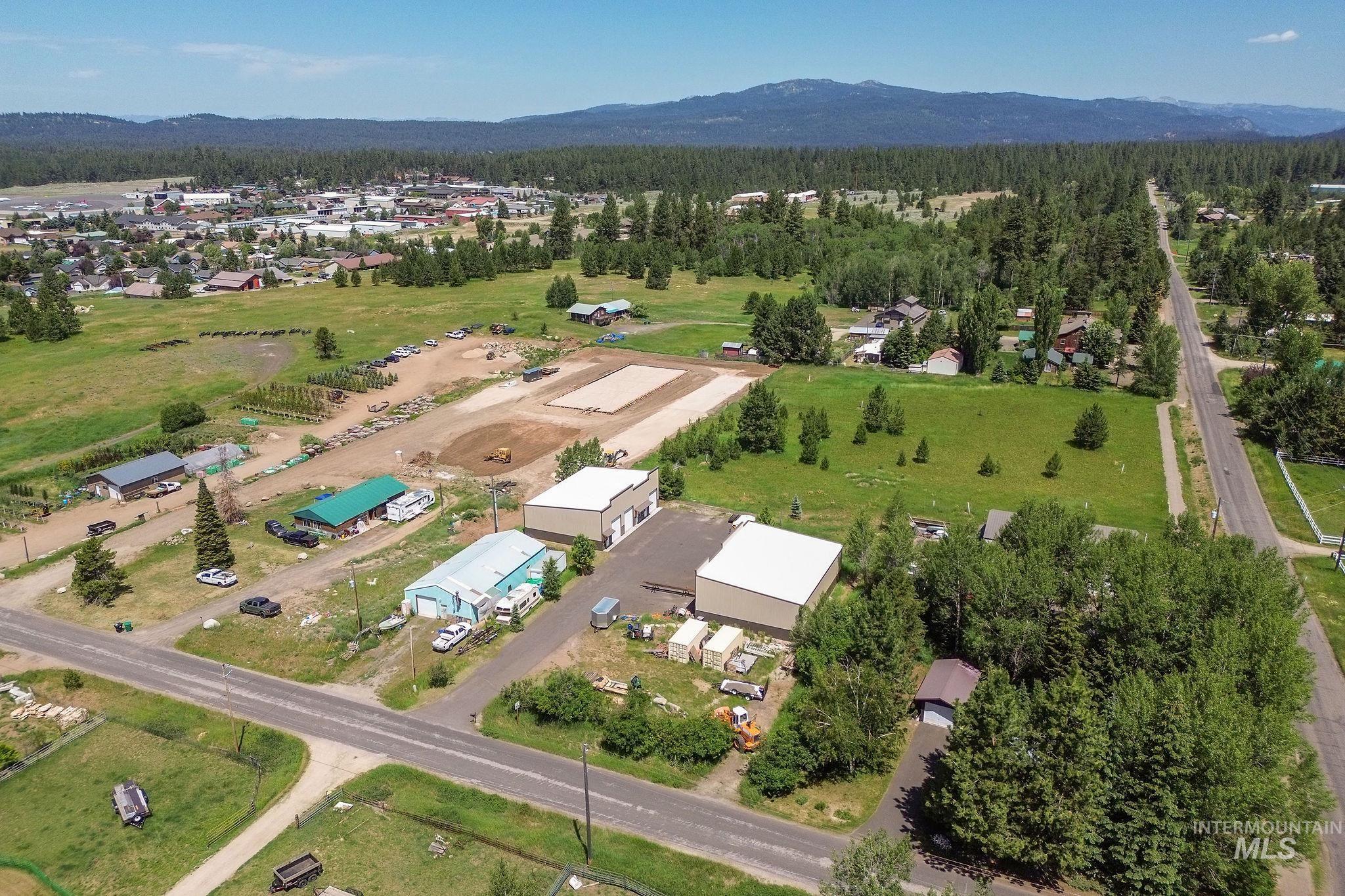 Aerial view of property's location featuring mountains and a forest