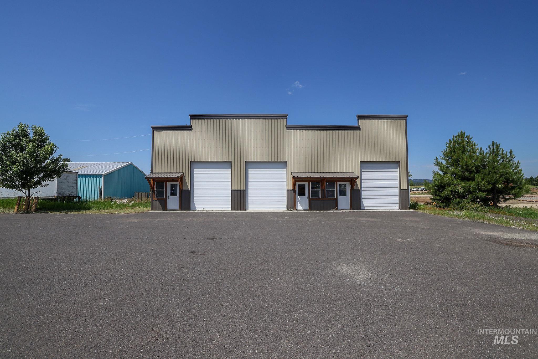 View of property with a detached garage