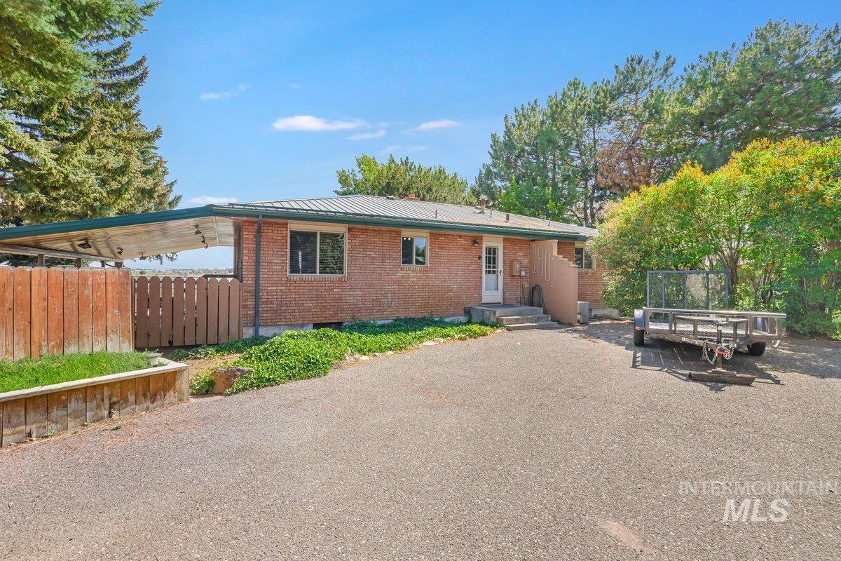 Back of house with brick siding and metal roof