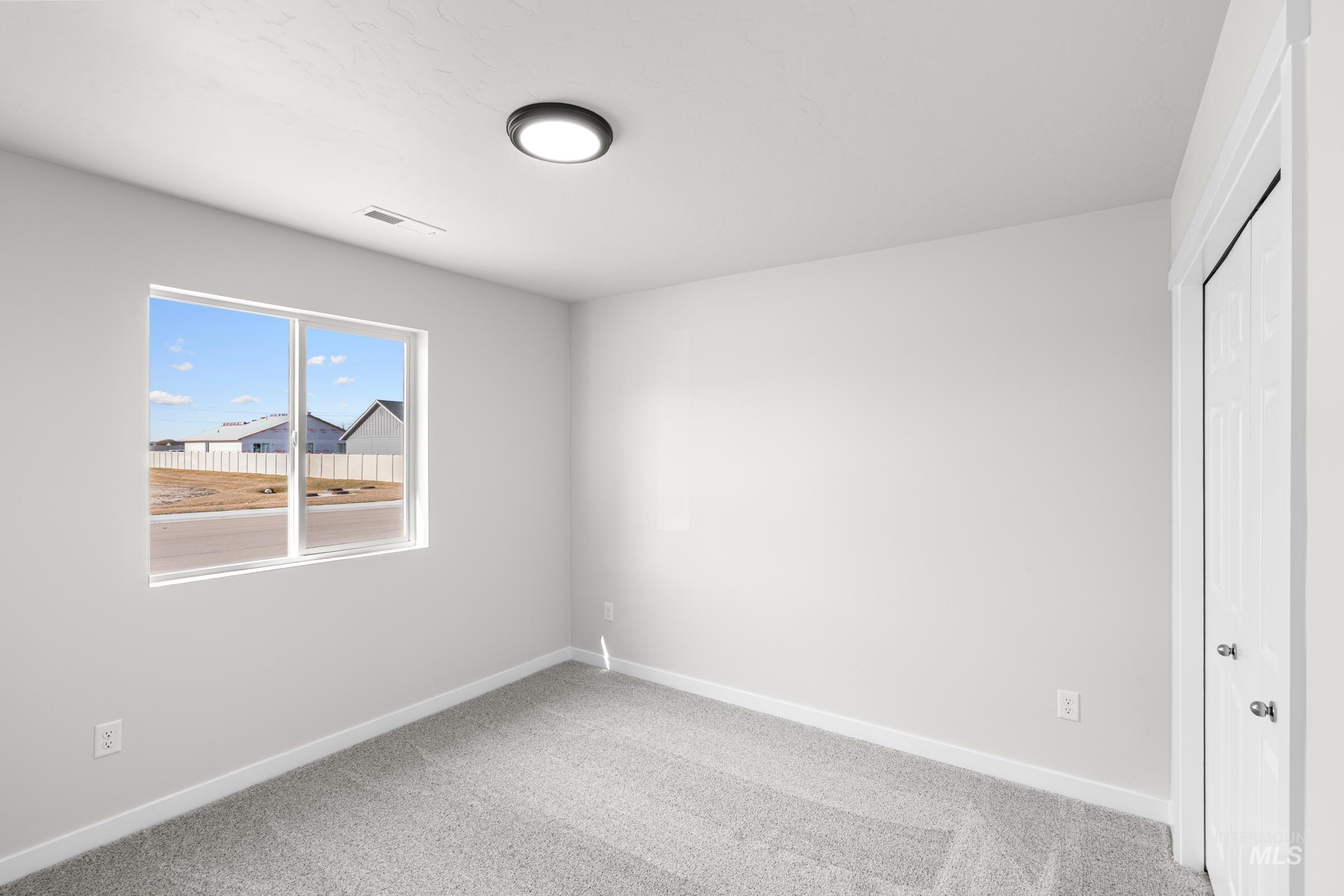 Unfurnished bedroom featuring a closet and light carpet