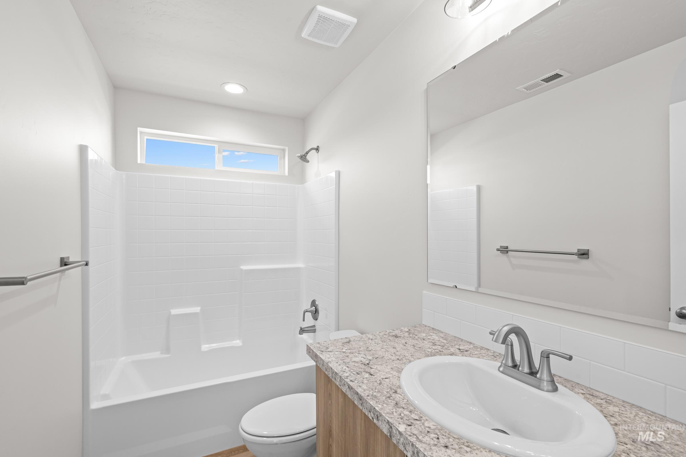 Bathroom with shower / bathtub combination and vanity
