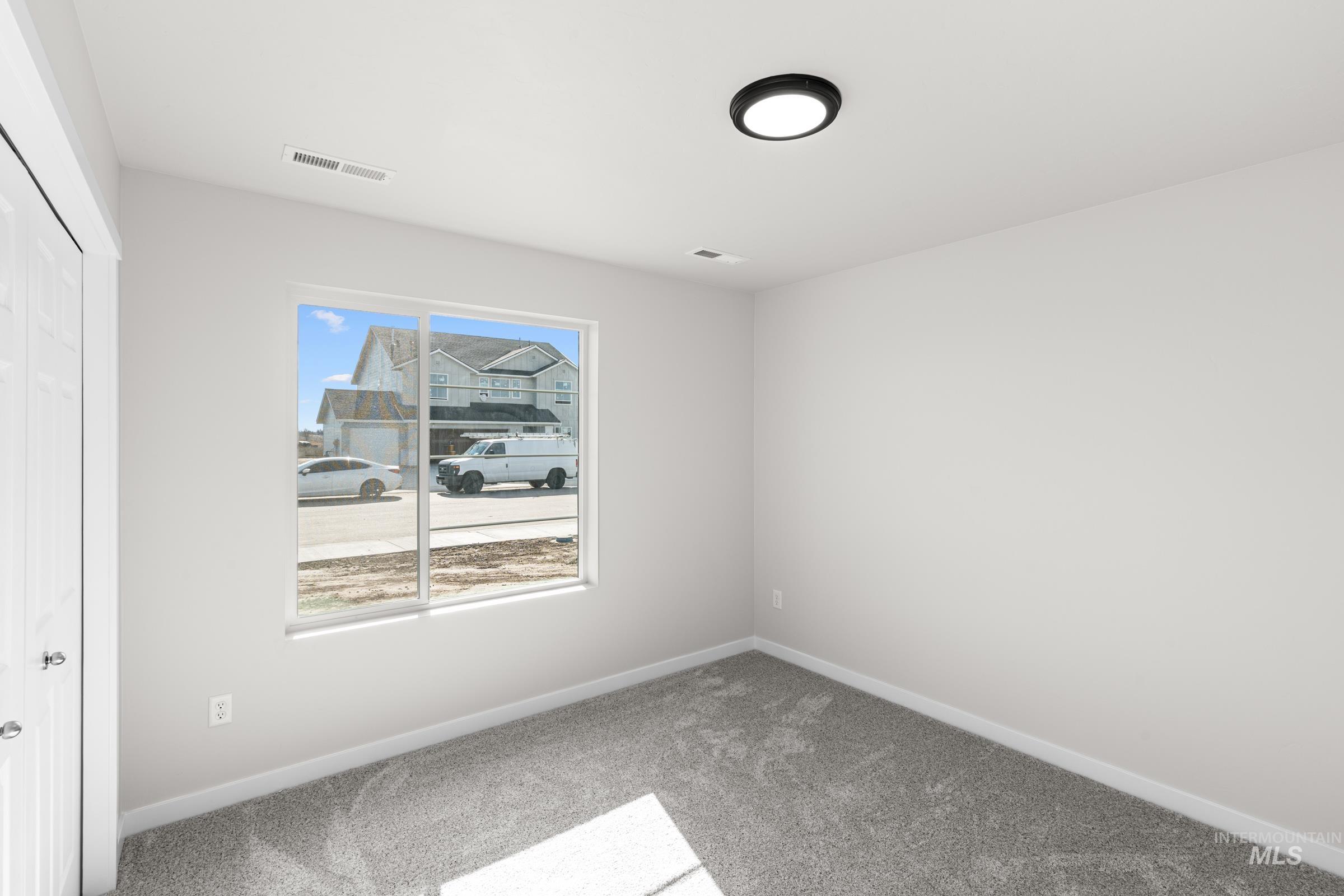 Unfurnished bedroom with a closet and light carpet