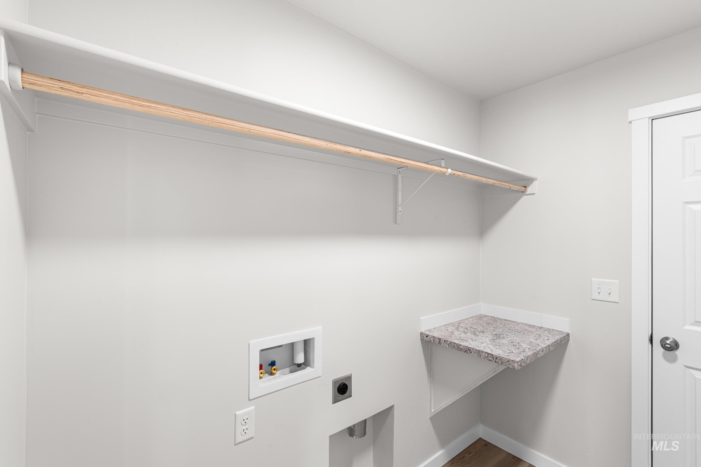 Laundry area with washer hookup, electric dryer hookup, and wood finished floors