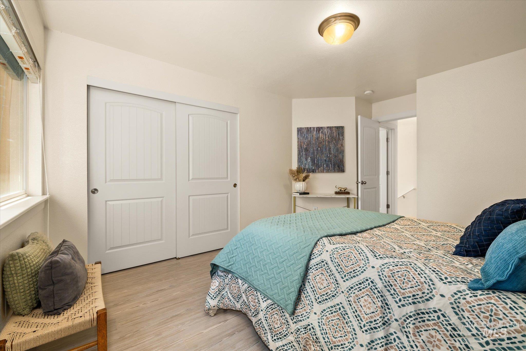 Bedroom featuring light wood-style flooring and a closet
