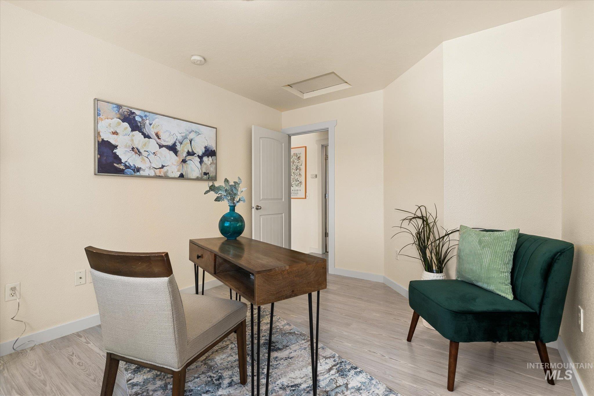Office area with attic access and light wood-type flooring