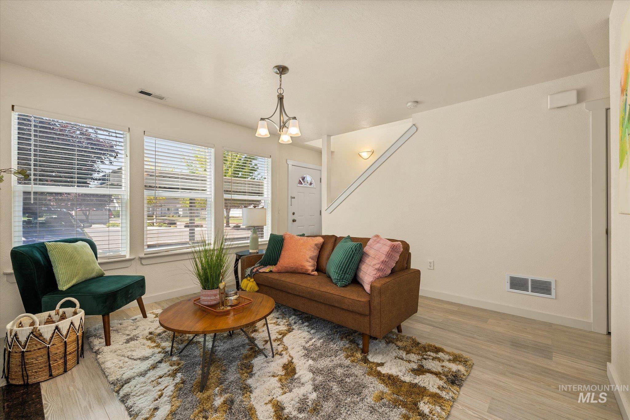 Living room with a chandelier and light wood-style floors