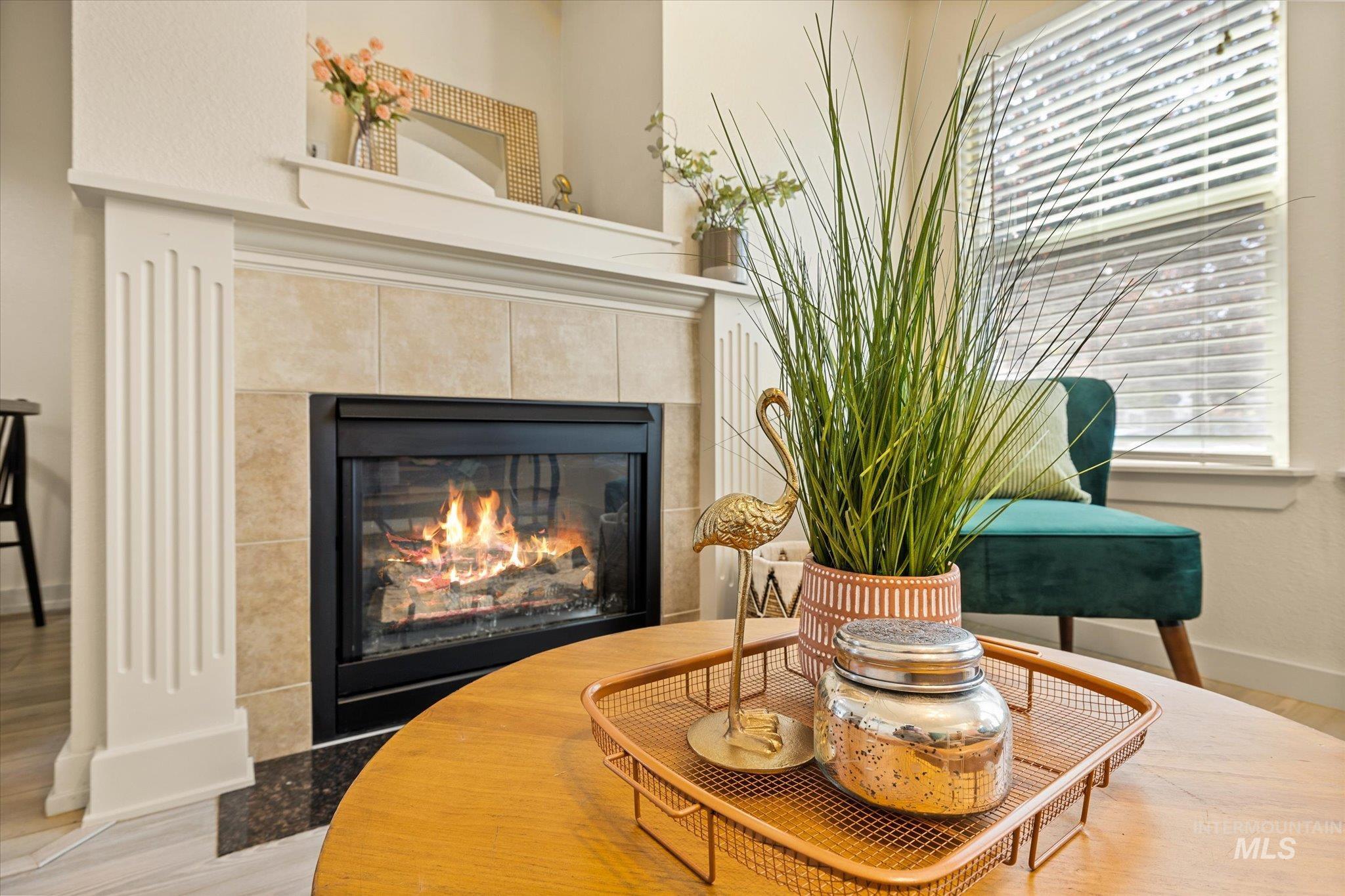 Detailed view of wood finished floors and a tile fireplace