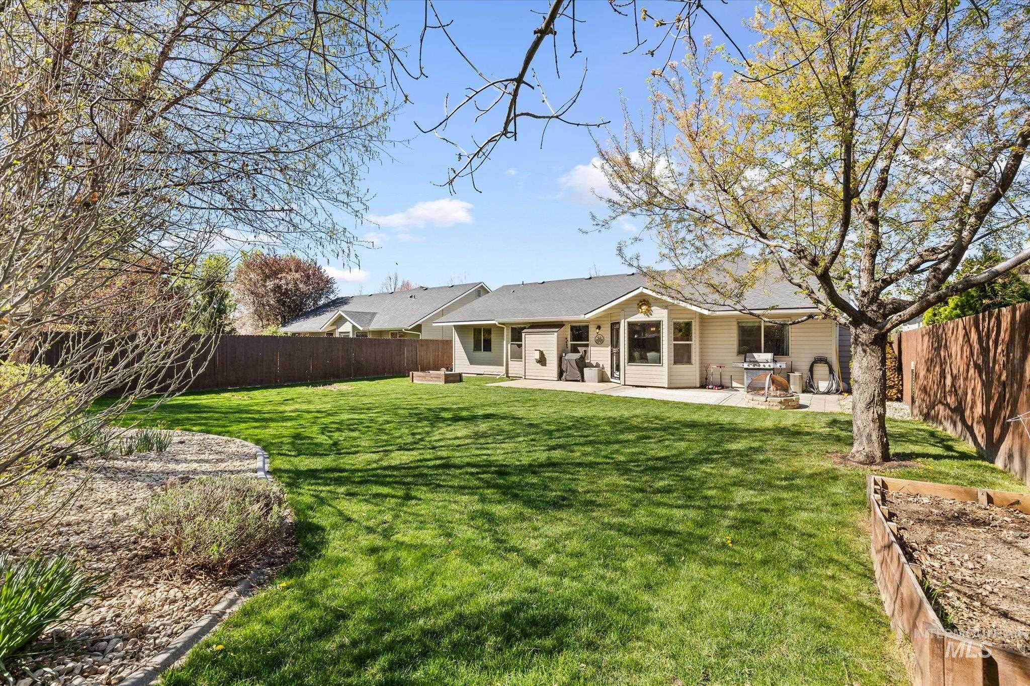 Rear view of house featuring a fenced backyard and a patio