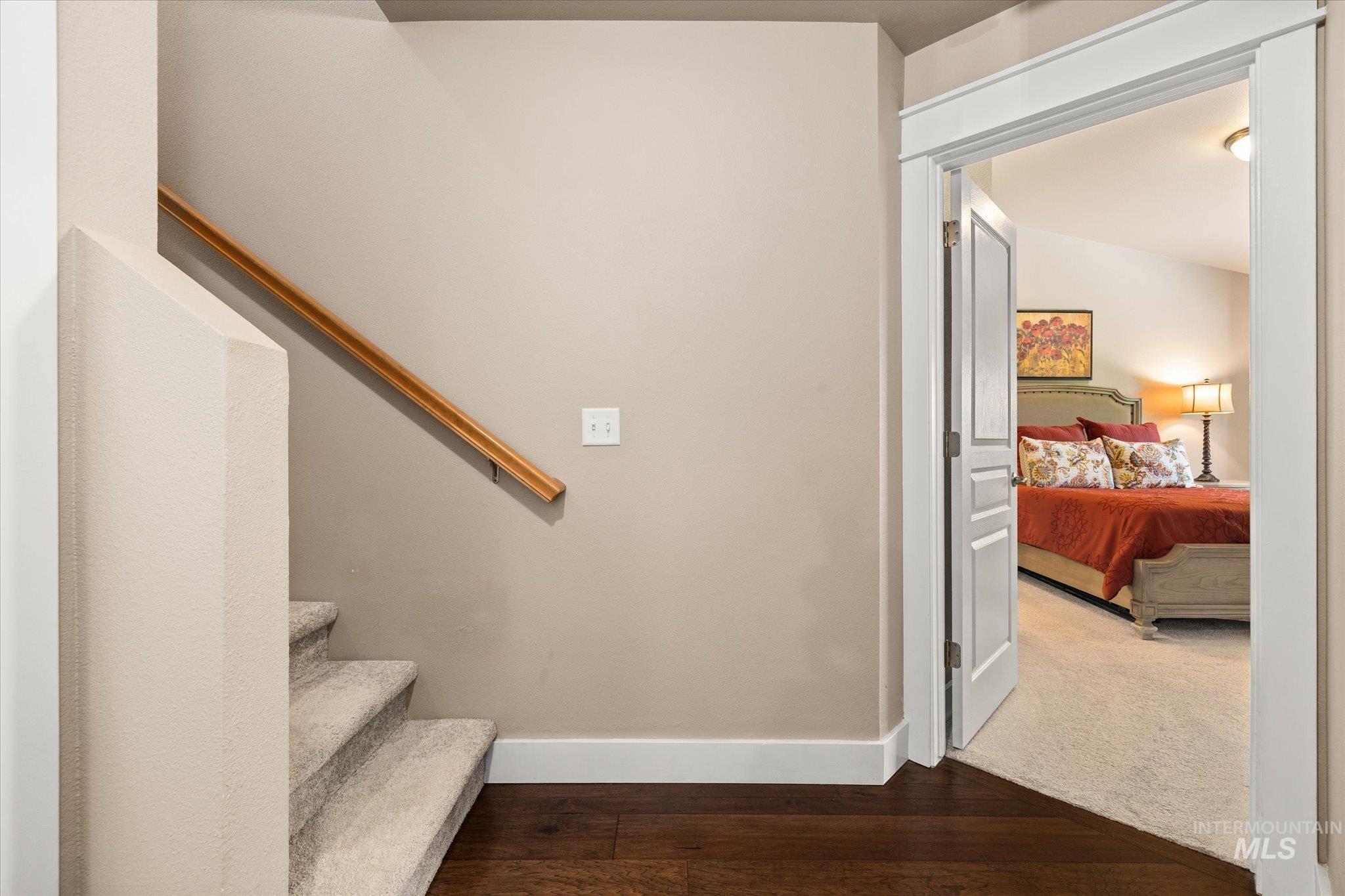 Stairs with baseboards and hardwood / wood-style floors