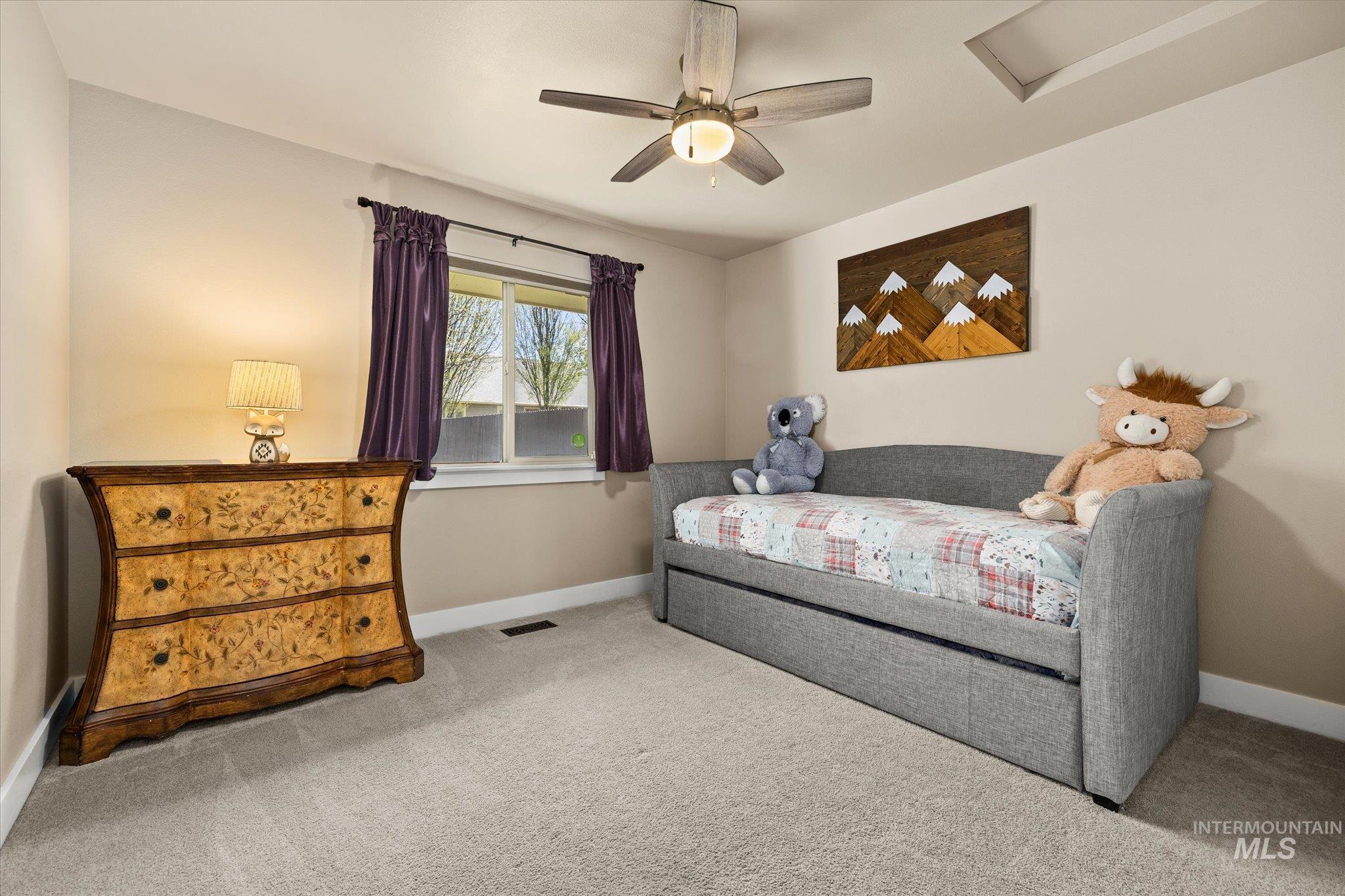 Bedroom featuring light colored carpet and ceiling fan