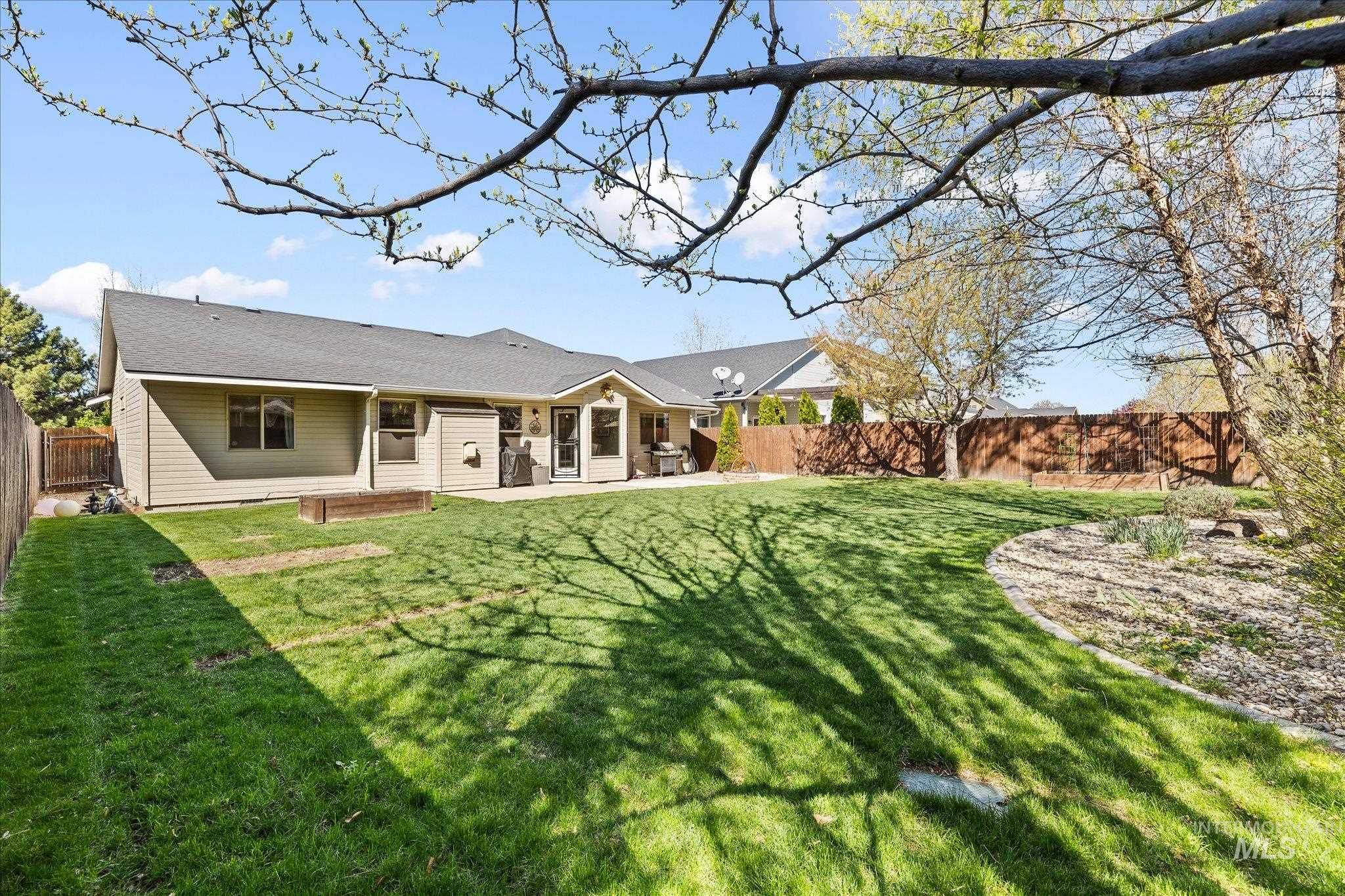Rear view of property with a fenced backyard and a patio area