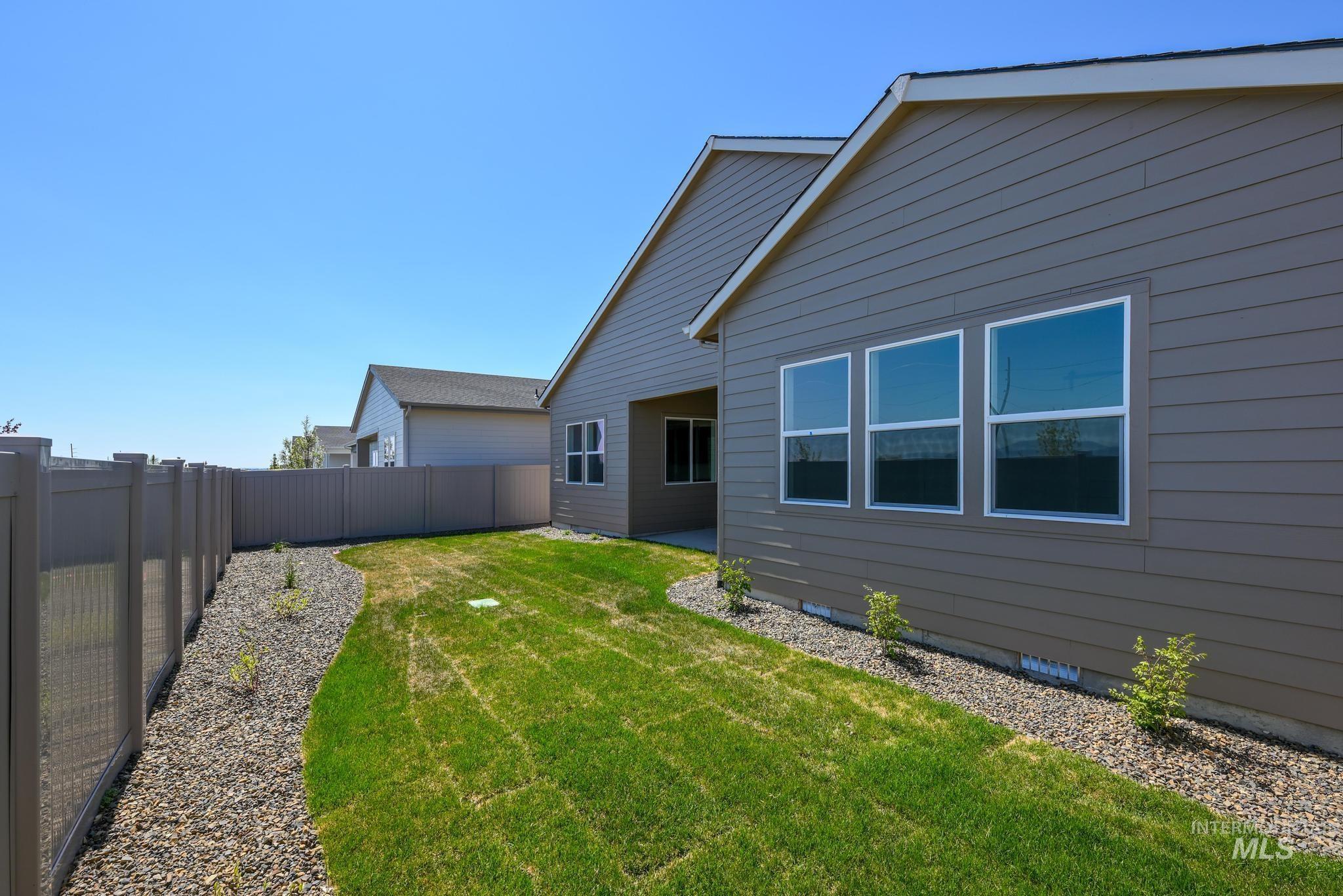 Back of property with a fenced backyard and a patio area