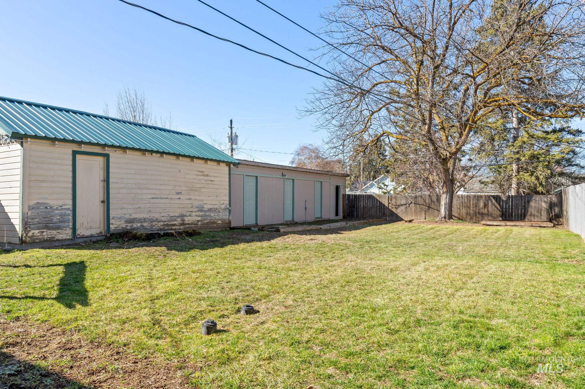 Fenced backyard with an outdoor structure