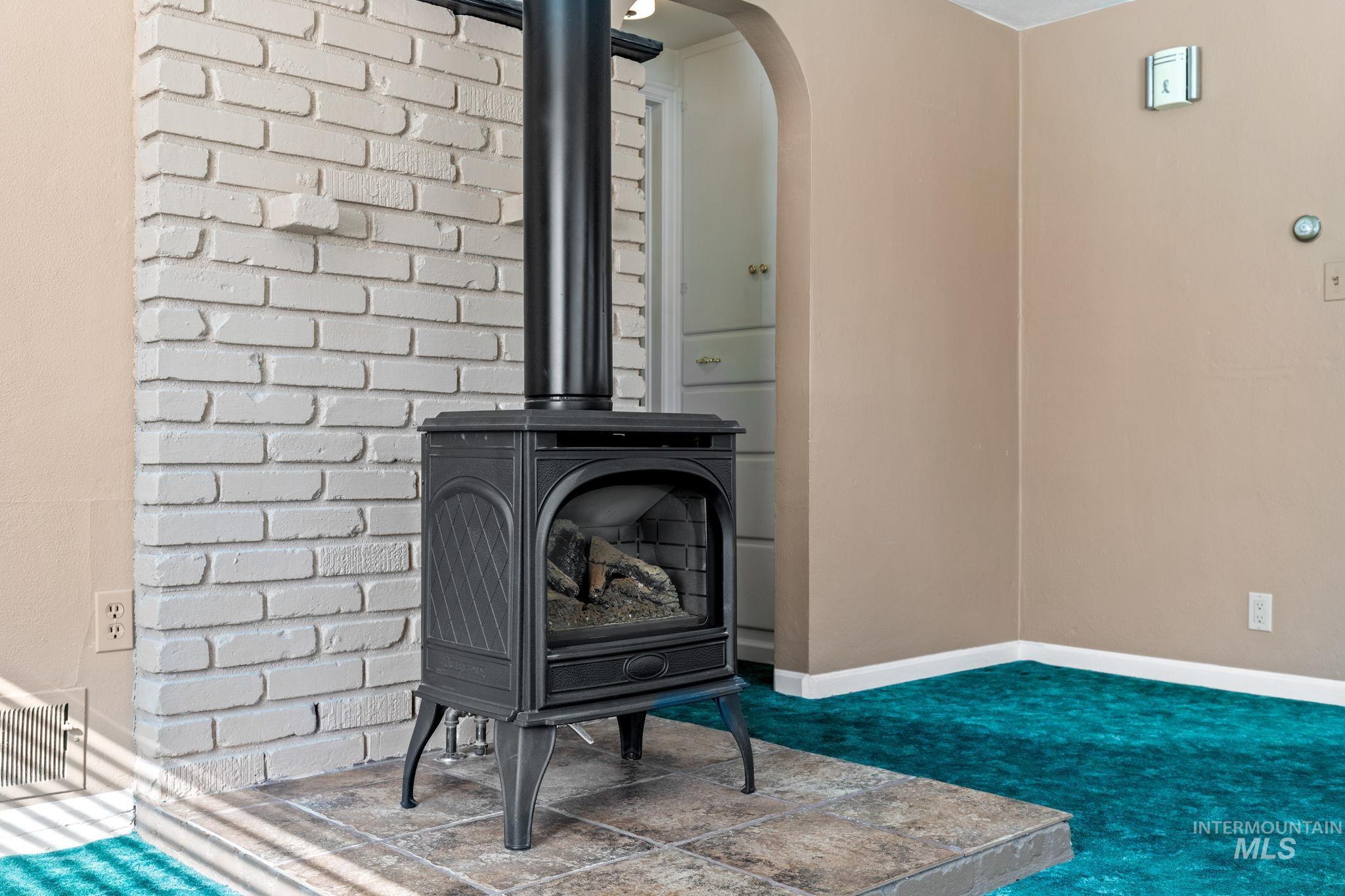 Detailed view of arched walkways, carpet flooring, and a wood stove