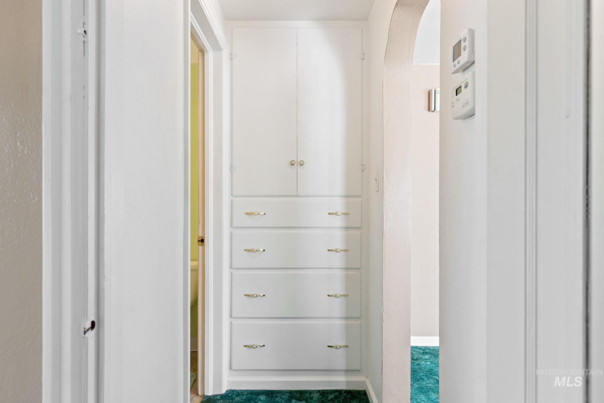 Walk in closet featuring arched walkways