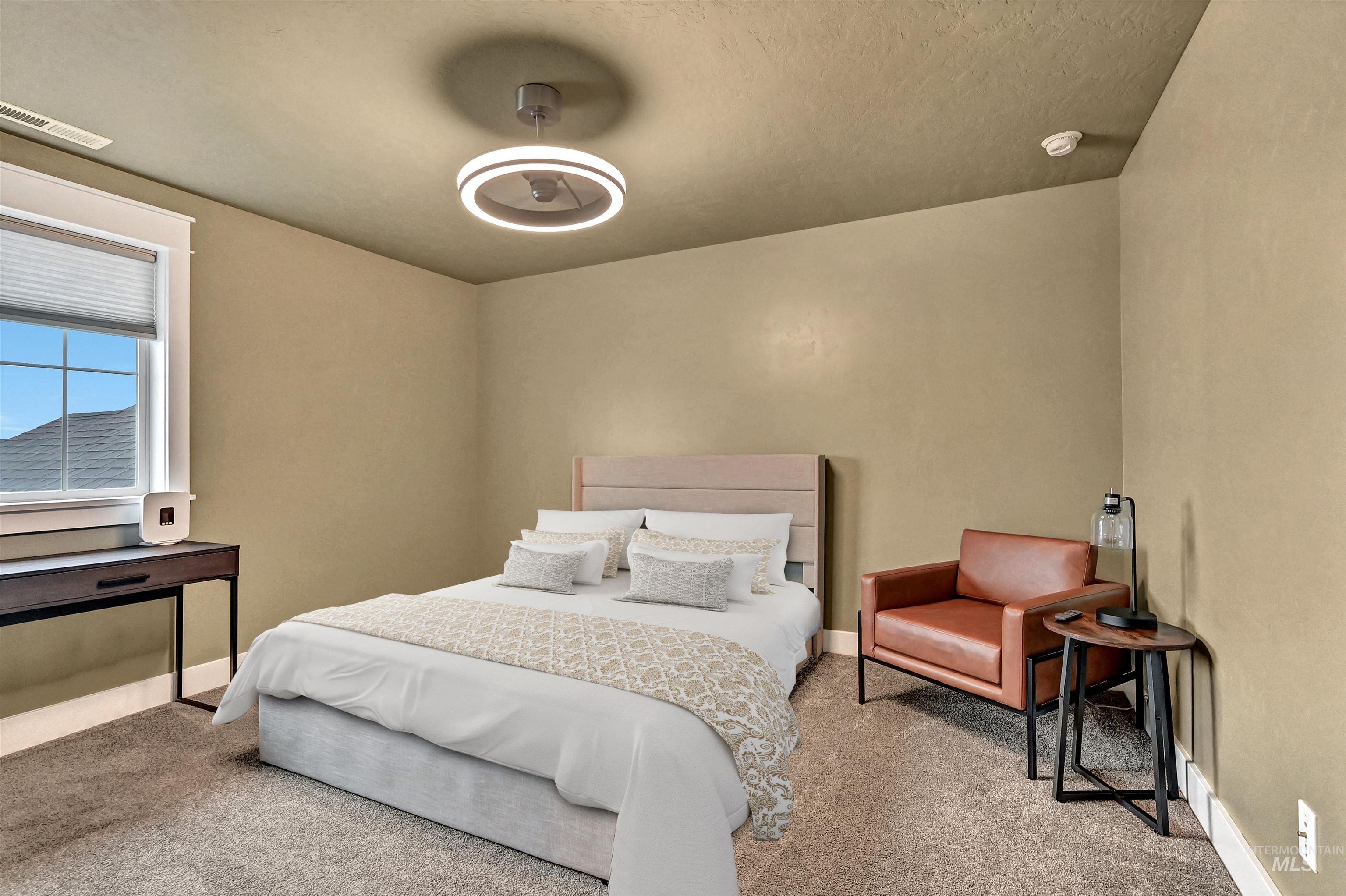 Bedroom featuring light carpet and expansive windows