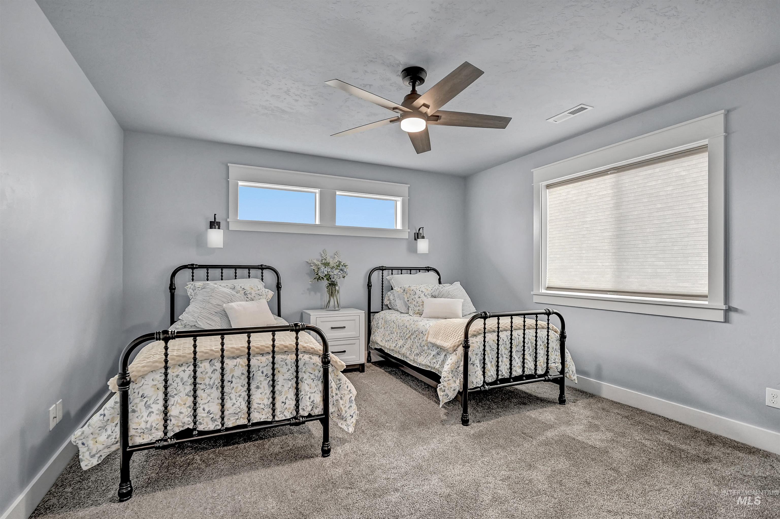 Bedroom featuring light carpet and expansive windows