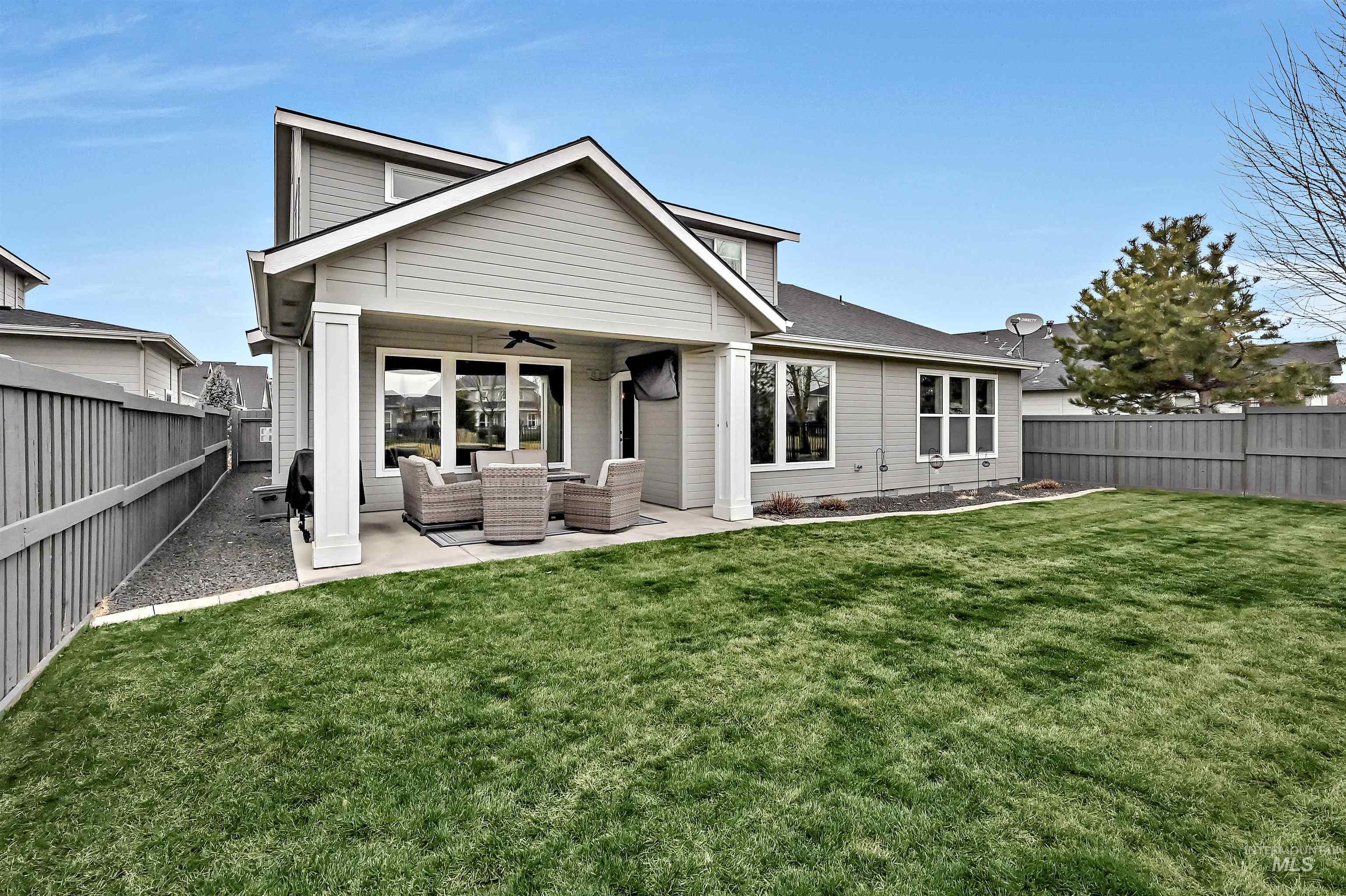 Rear view of house featuring outdoor lounge area, a ceiling fan, a fenced backyard, and a patio area