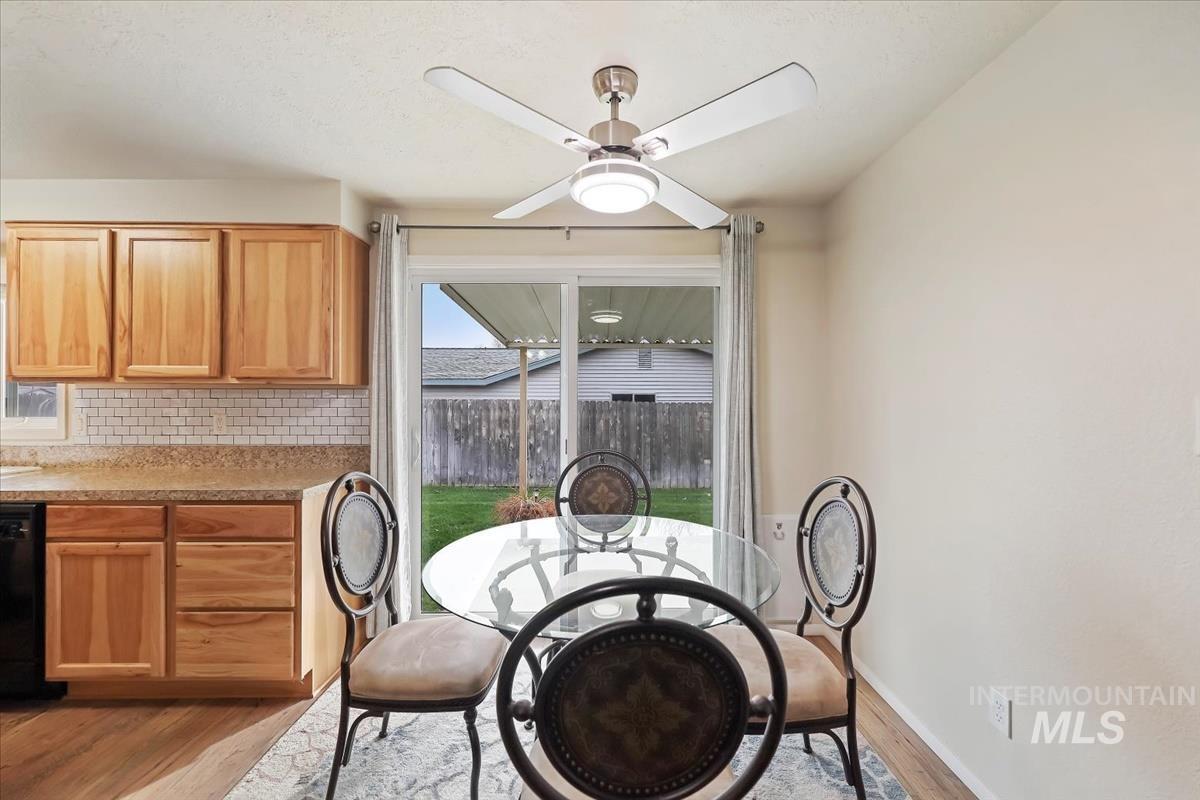 Dining area featuring light wood-style flooring and ceiling fan
