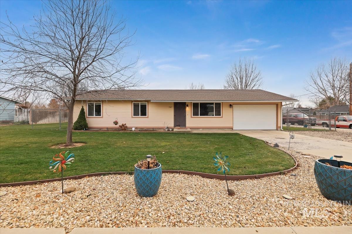 Ranch-style house featuring a porch, driveway, and a garage